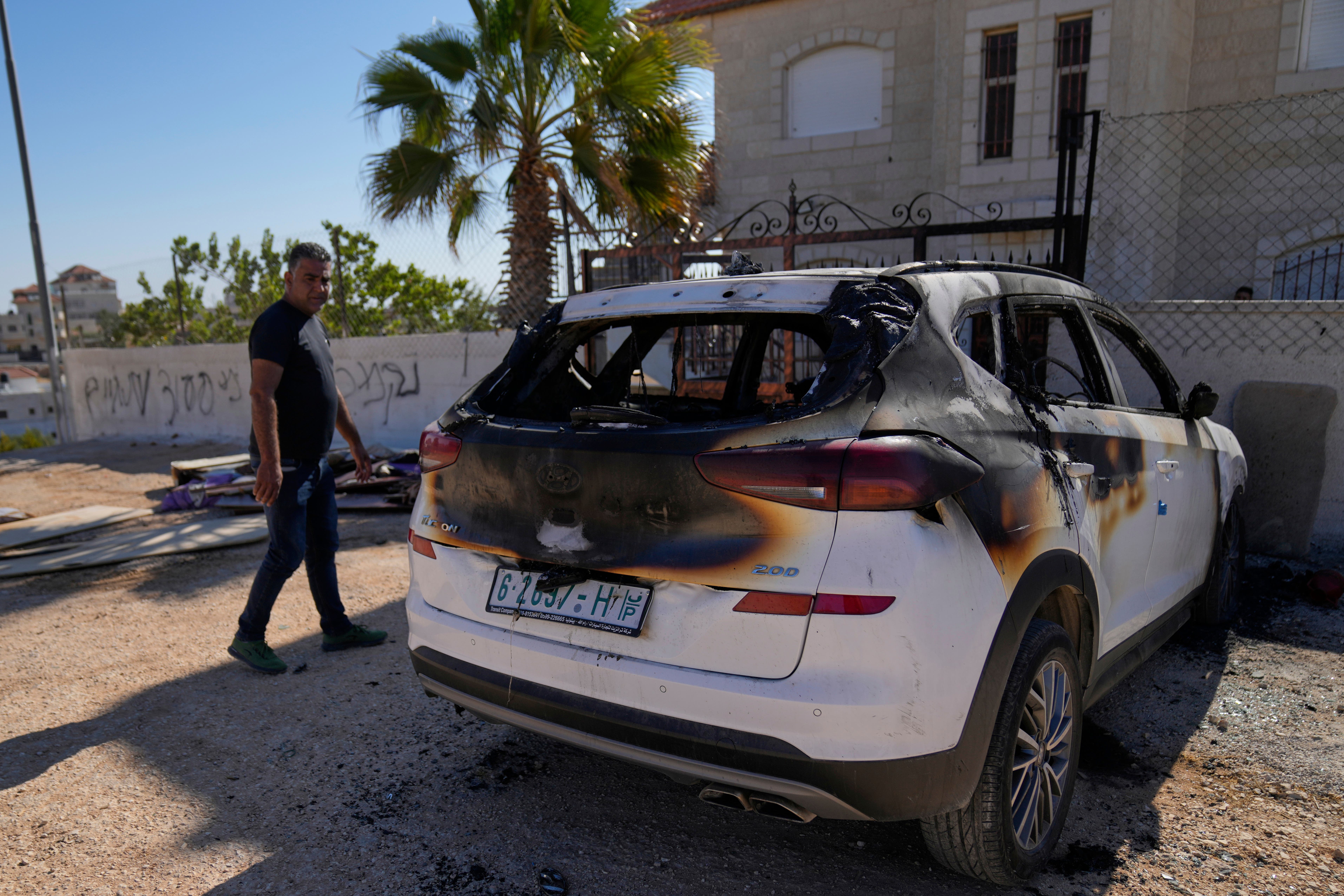 A vehicle that was burnt out by Israeli settlers in an attack that left three Palestinians killed and burnt several vehicles and damaged homes, according to residents in the West Bank village of Kafr Malik, east of Ramallah, Thursday (Nasser Nasser/AP)