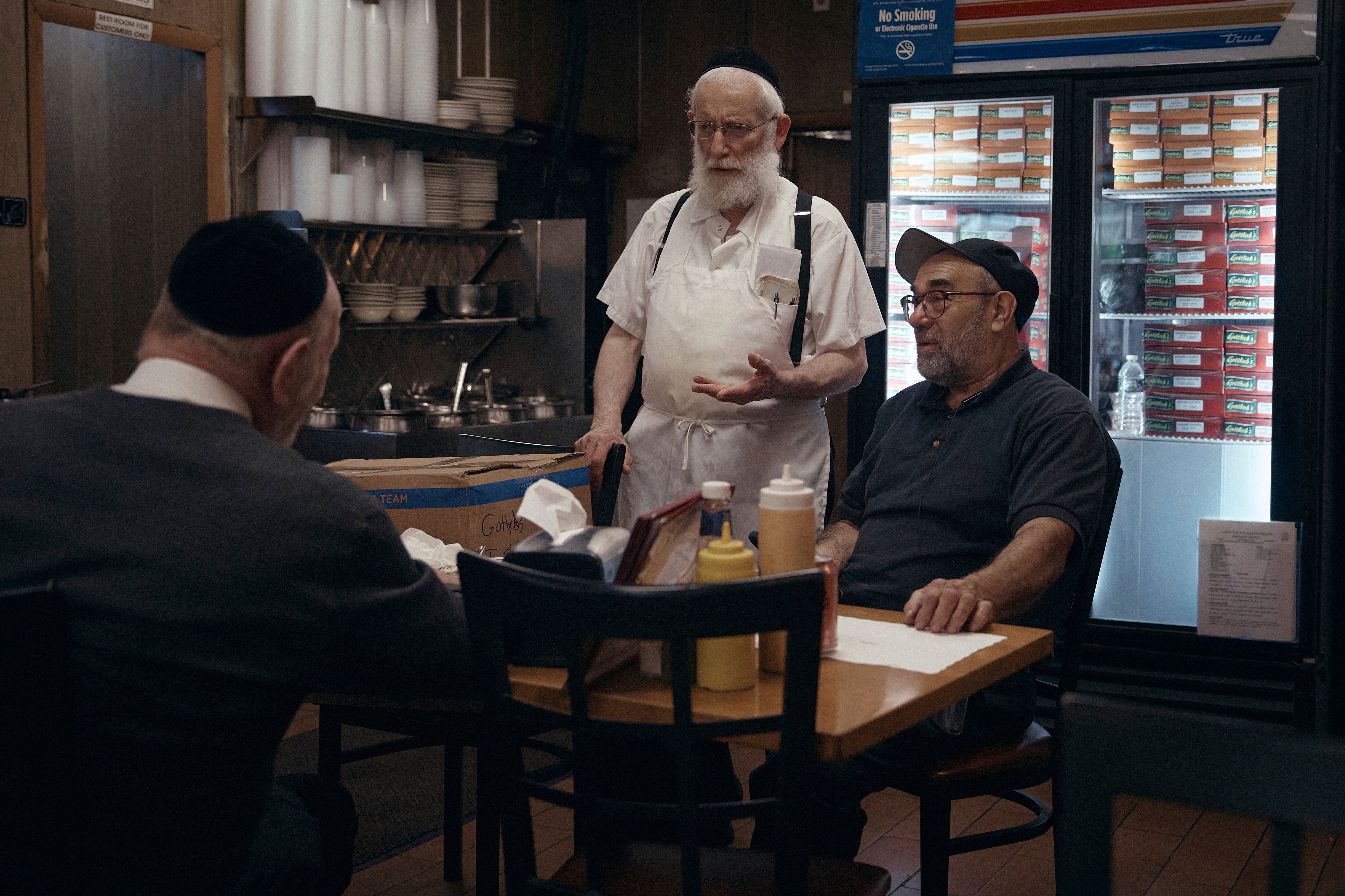 Hasidic Jewish men chat inside Gottlieb's Restaurant on Monday, June 16, 2025, in the Brooklyn borough of New York