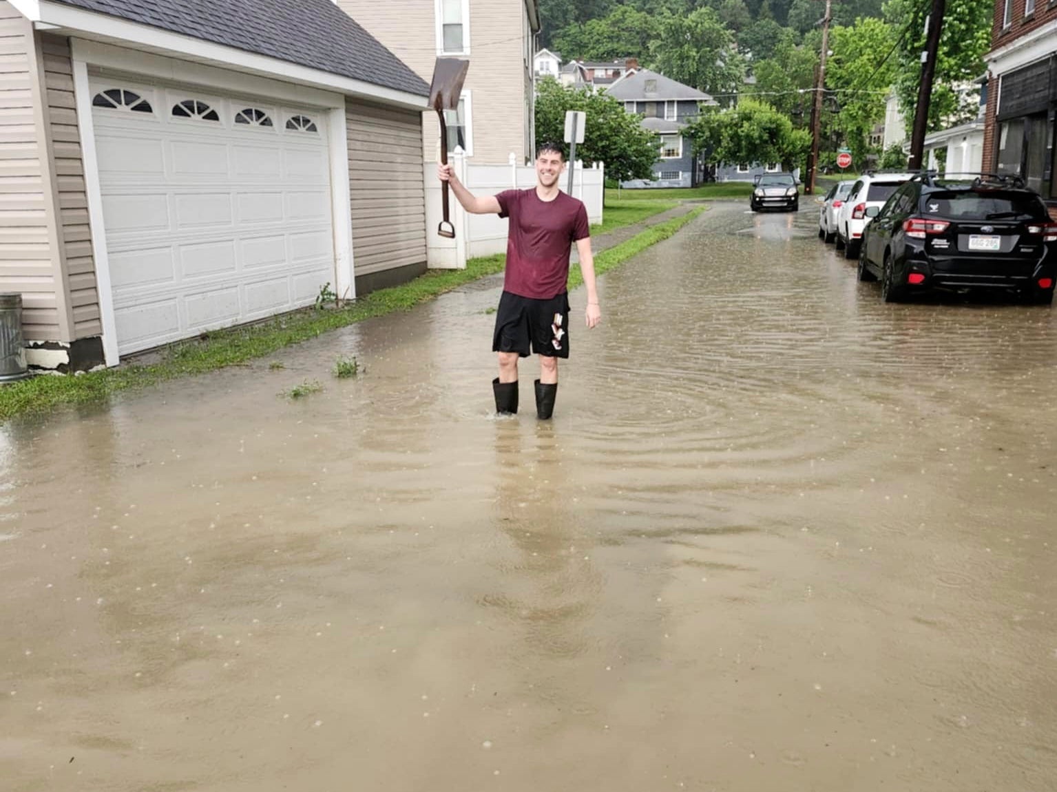 West Virginia resident Walker Holloway stands in several inches of water outside his home in the Edgwood neighborhood following flash flooding in Ohio County, West Virginia