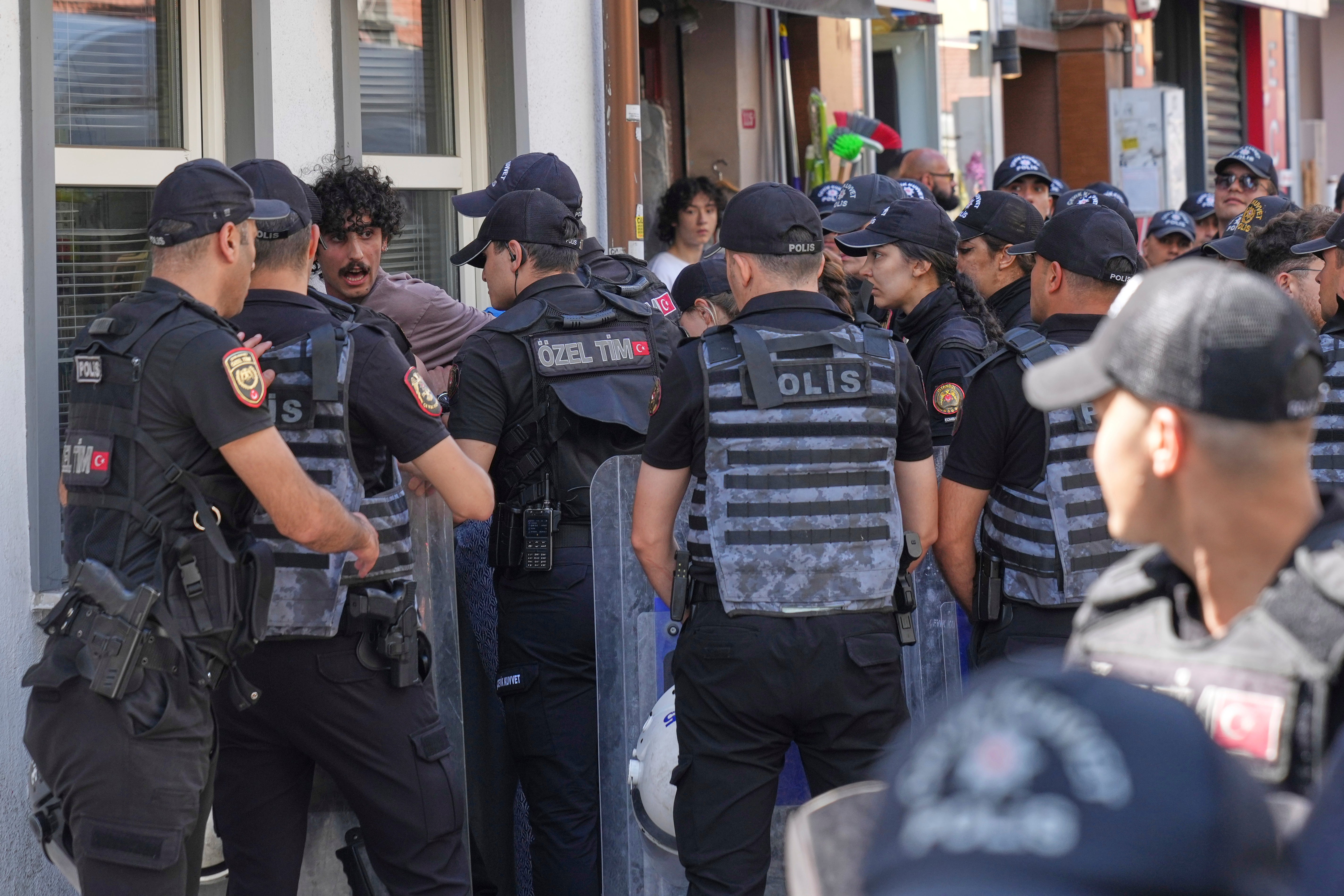 A person is detained by Turkish police officers during the annual LGBTQ+ Pride March, in Istanbul, Turkey, Sunday, June 29, 2025. (AP Photo/Dilara Acikgoz)