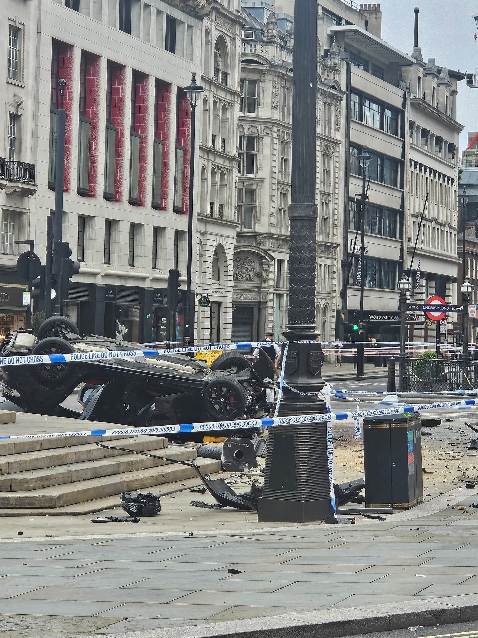 The car was left lying on its roof with debris strewn across the ground