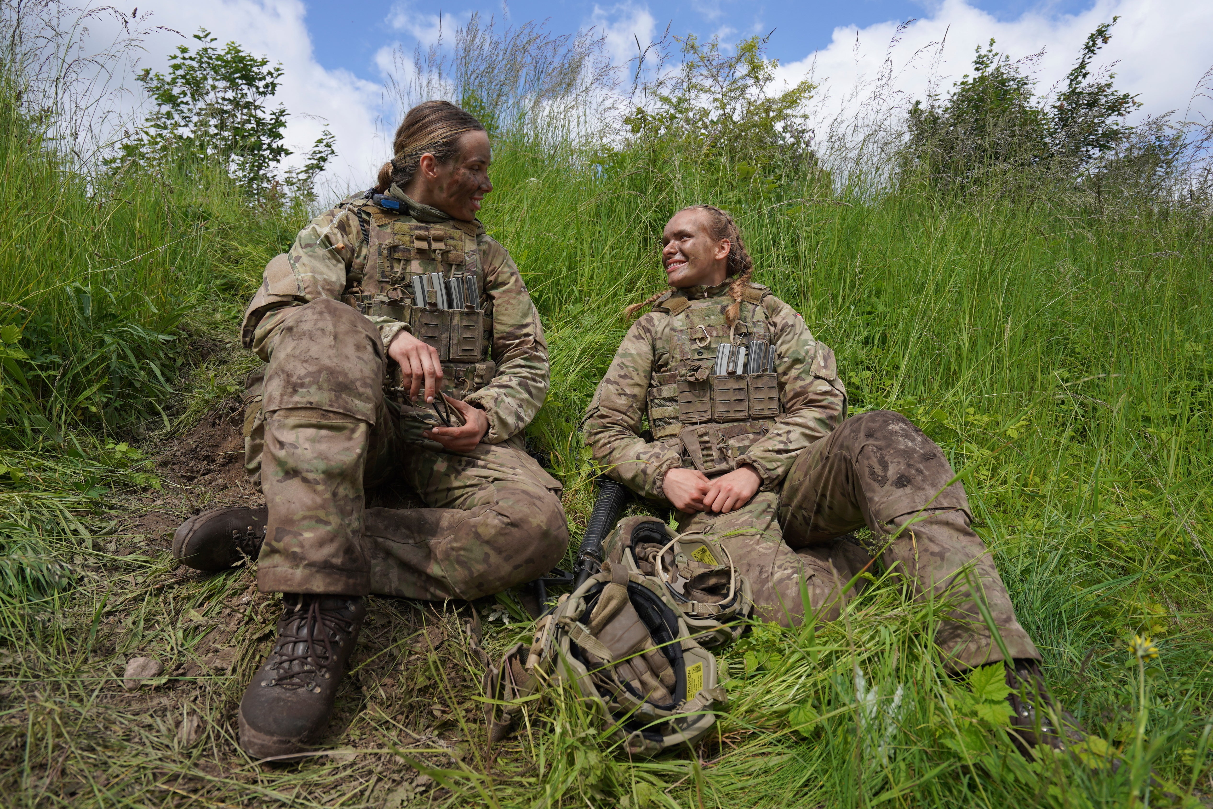 20-year-old conscript Katrine, right, speaks with another female conscript during final exercises at a training area close to Royal Danish Army’s barracks in Hovelte, 25 kilometres north of Copenhagen, Denmark, Wednesday, June 11, 2025