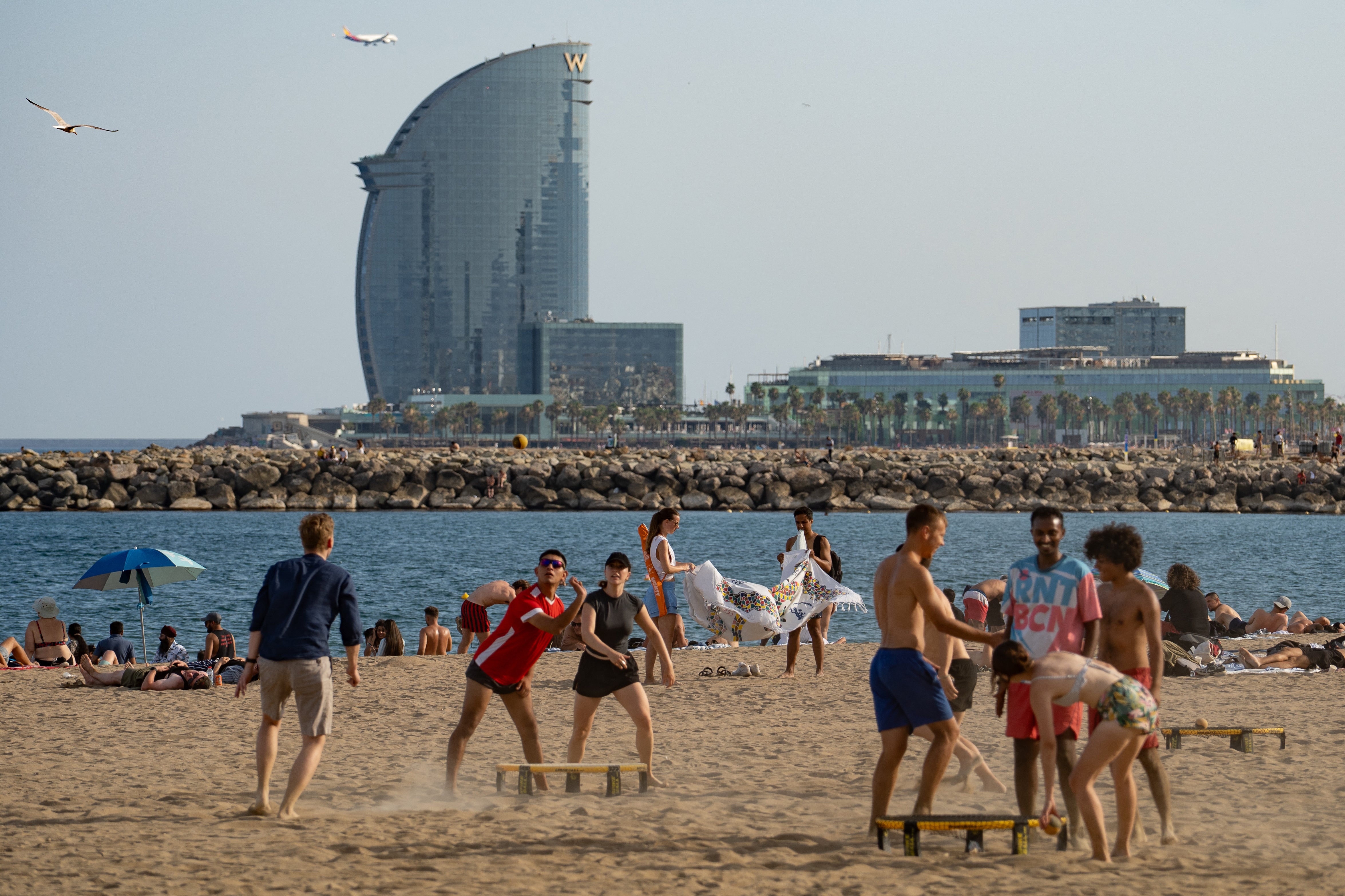 People at Barceloneta beach in Barcelona, on June 27, 2025, a day before the first heatwave of the year is officially expected to begin