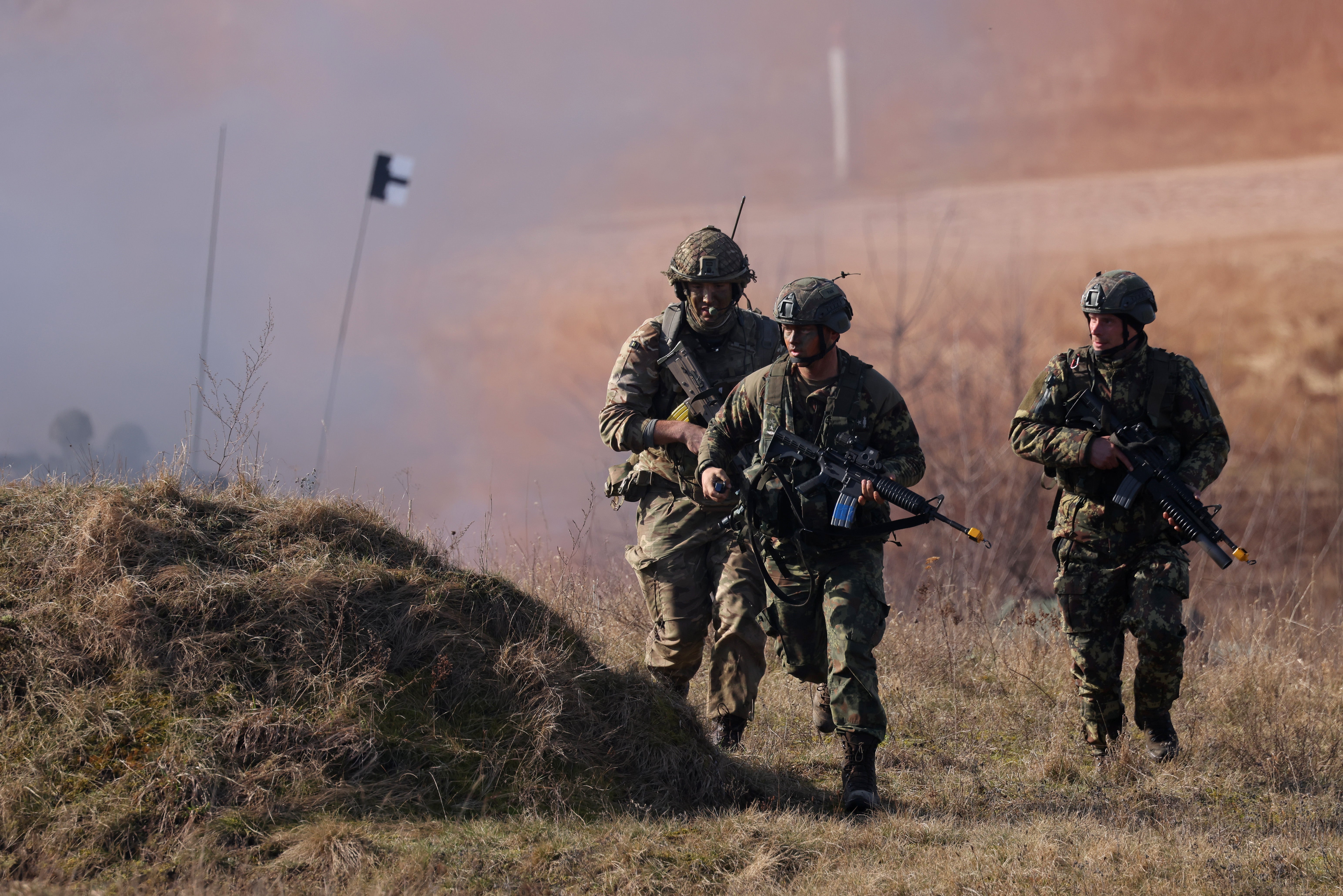 Soldiers from the 2nd Battalion Royal Anglian infantry unit storm during a Nato simulation in Poland