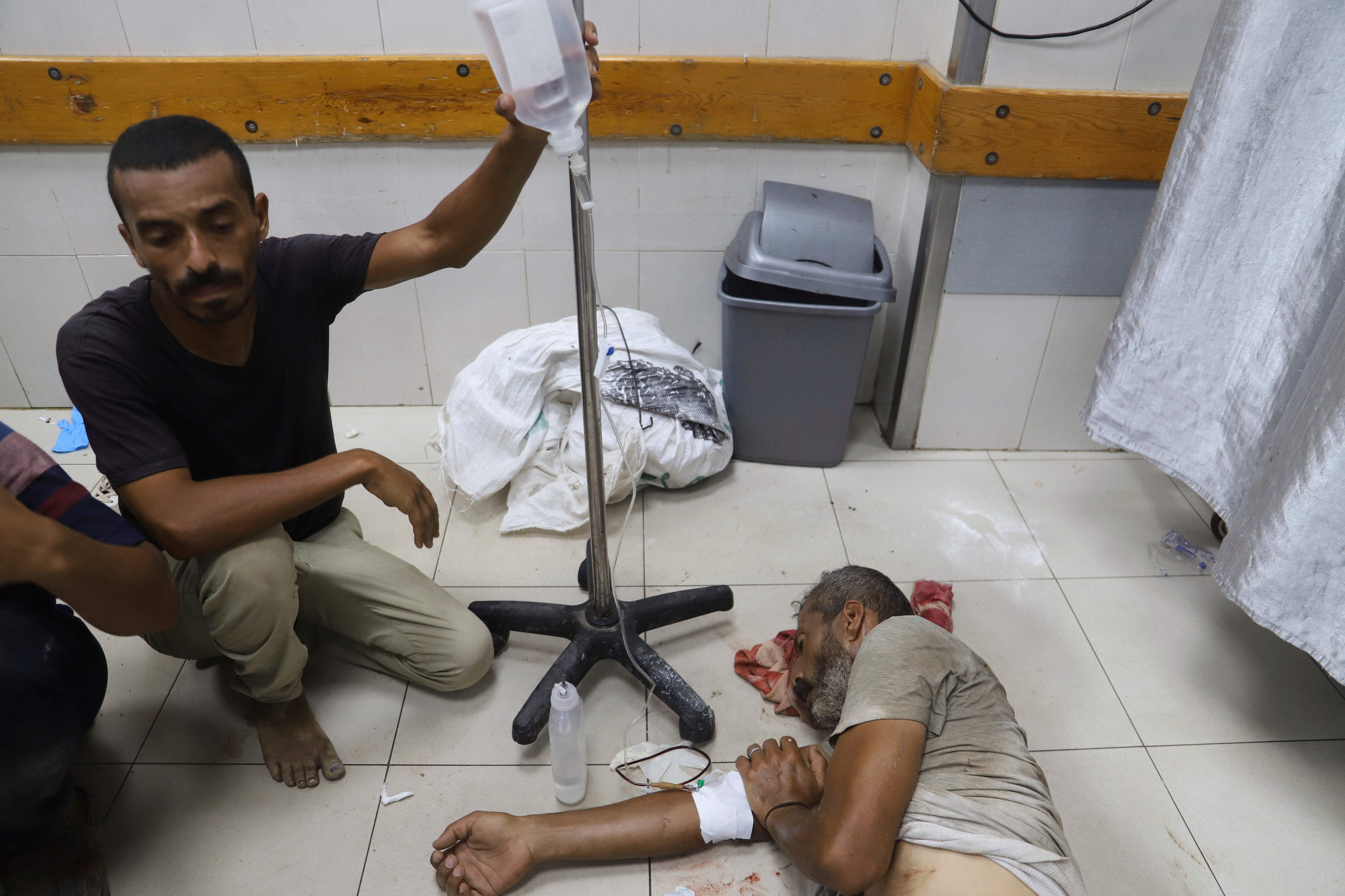 A Palestinian man wounded while returning from an aid distribution centre is treated in Khan Younis