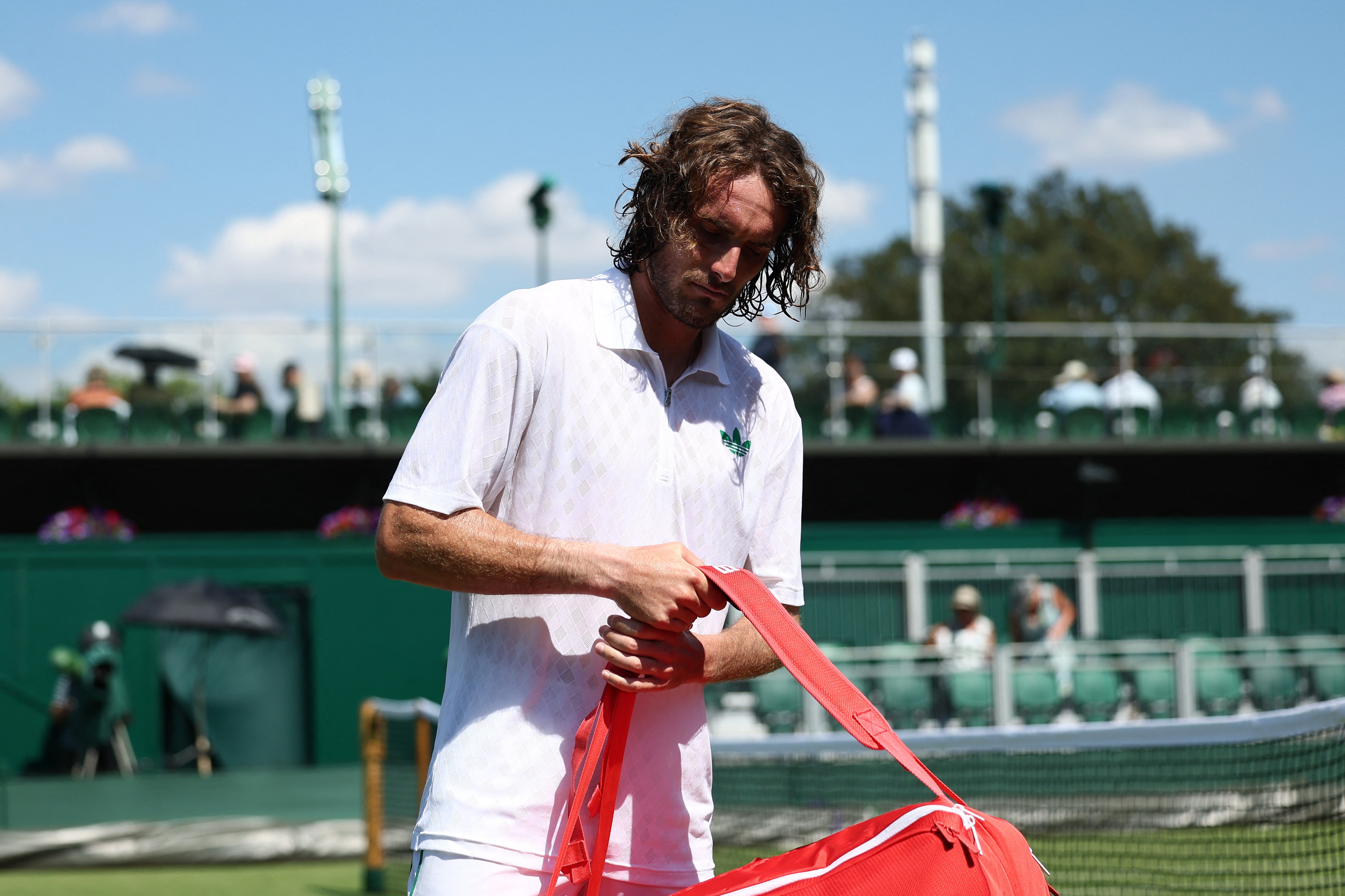 Greece's Stefanos Tsitsipas looks dejected after losing his first round match by walkover