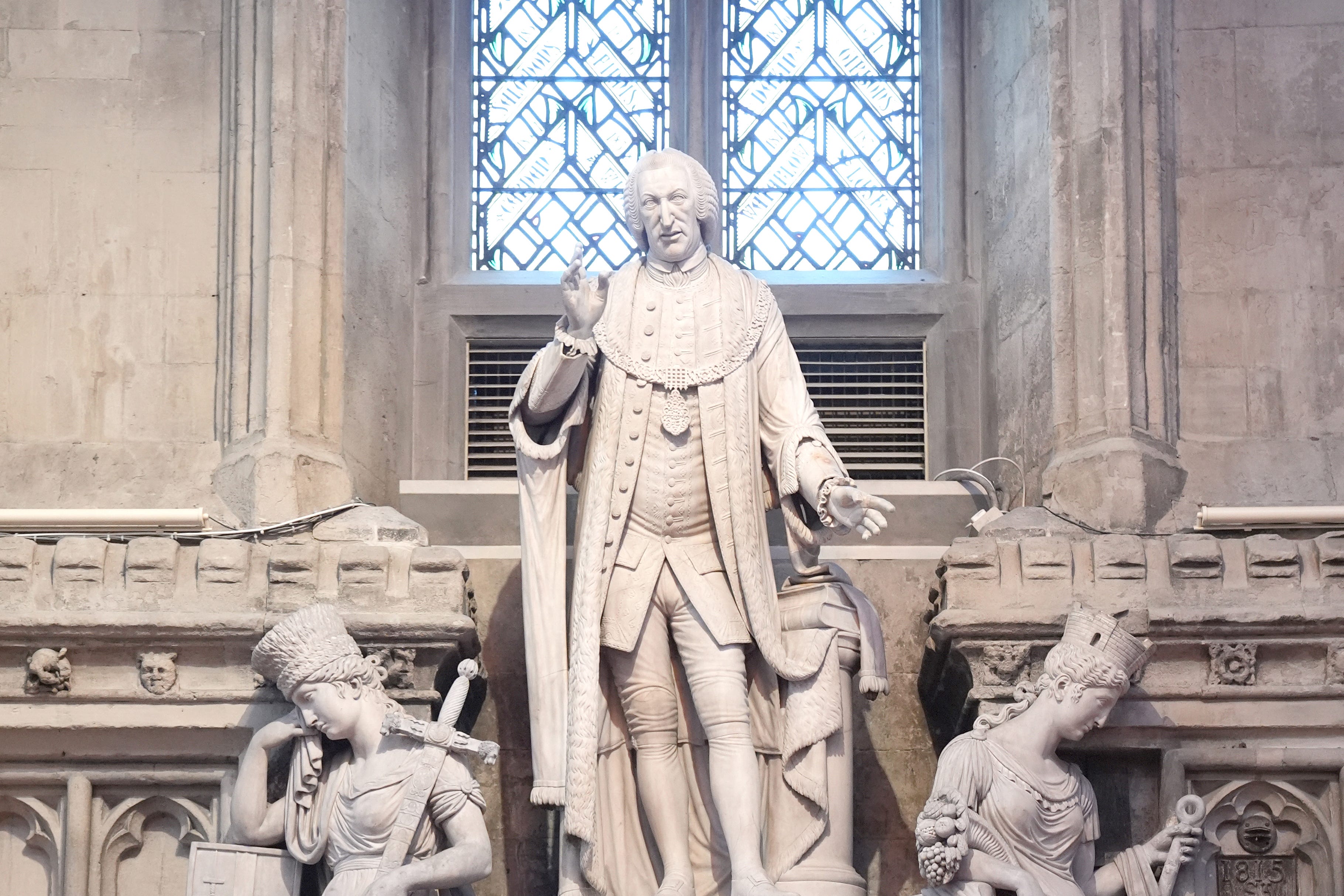 A plaque condemning slave traders is attached to a statue of William Beckford at the Guildhall in London (Stefan Rousseau/PA)