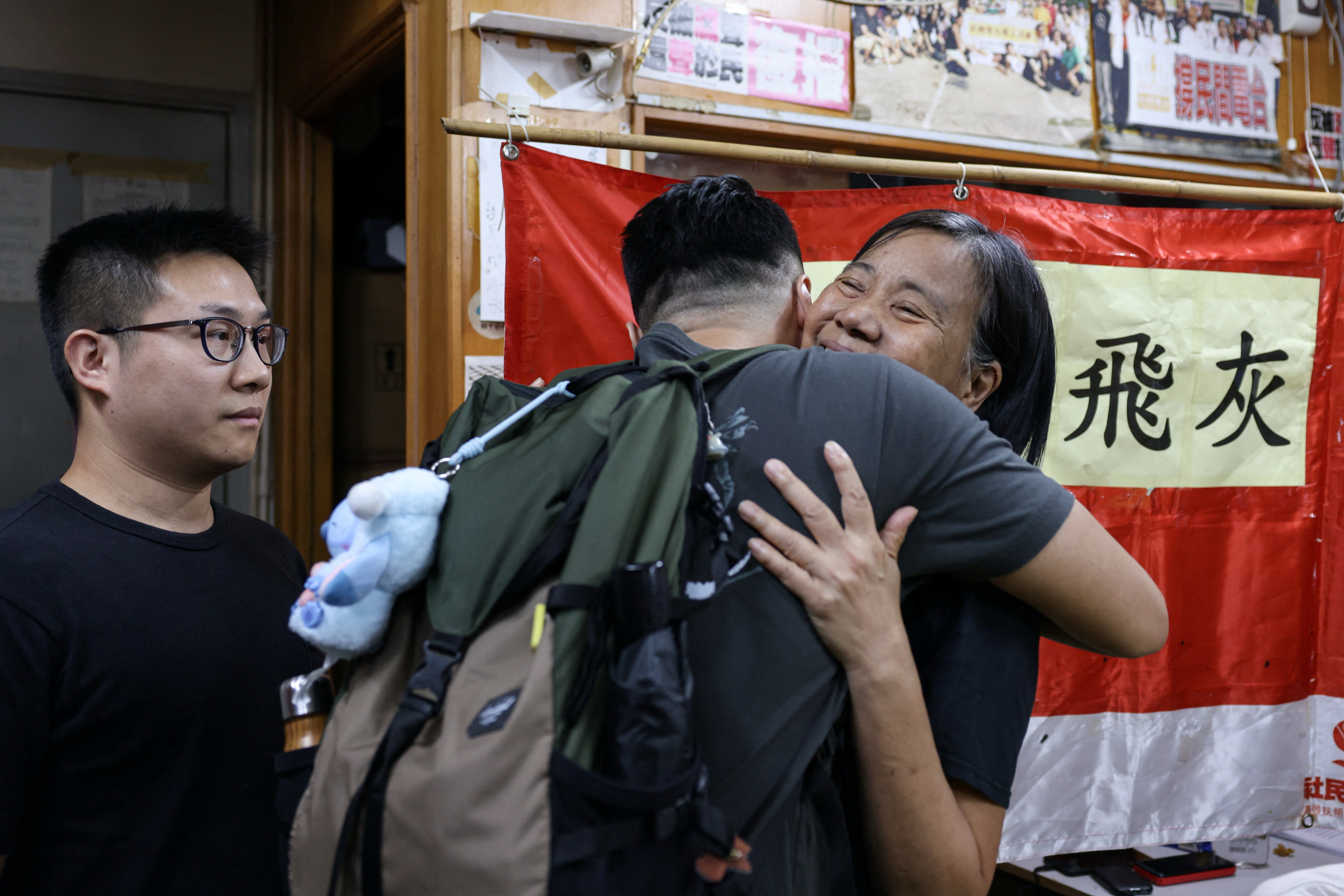 Chan Po Ying, chair of Hong Kong’s League of Social Democrats, hugs party member Jimmy Sham, recently released from prison, before a press conference to announce the party’s dissolution amid China’s national security law, in Hong Kong, China