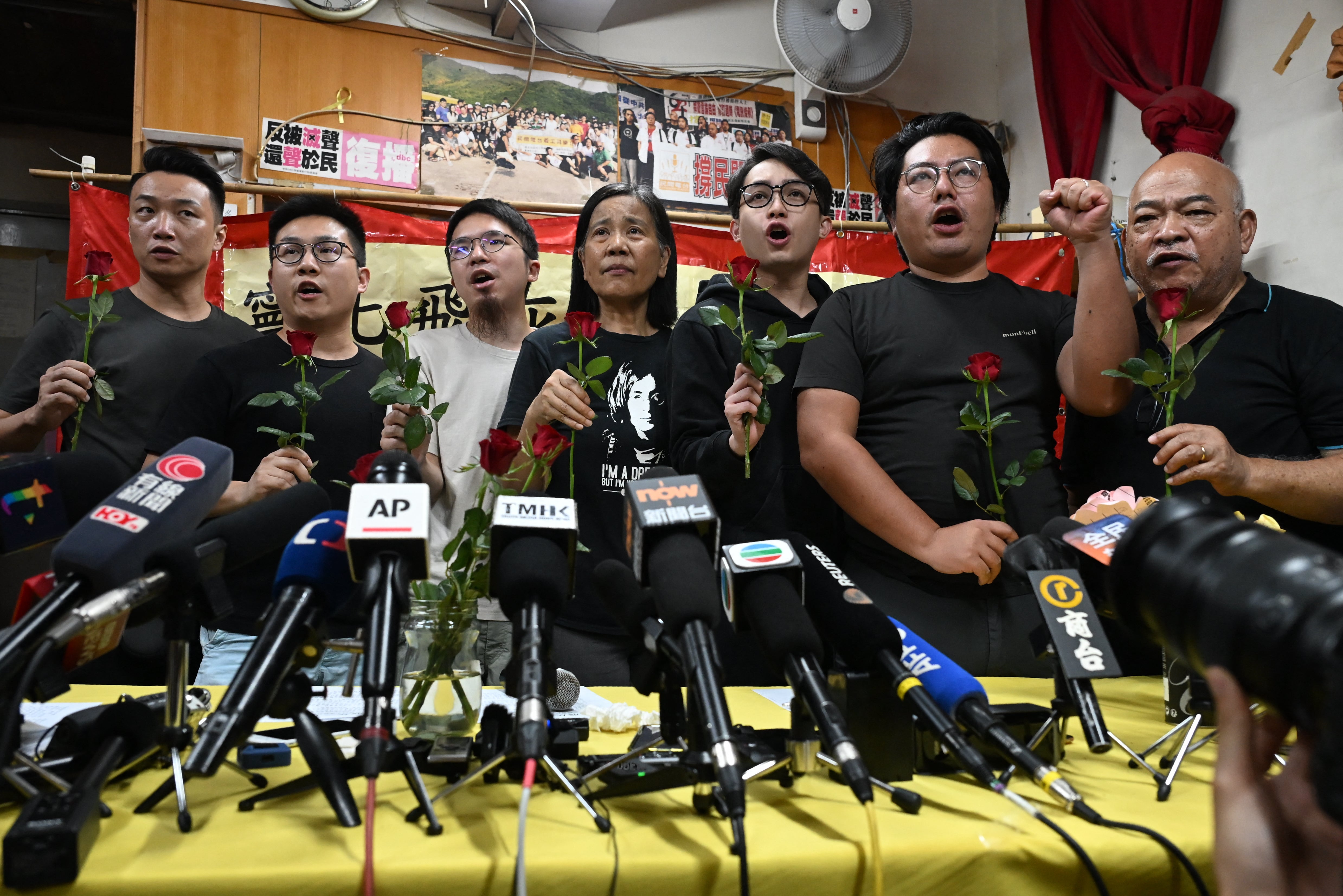Members of the League of Social Democrats with leader Chan Po Ying (centre) shout slogans after a press conference at their headquarters in Hong Kong