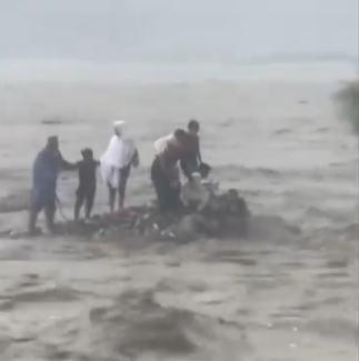 Video shows family stranded in the middle of a raging river