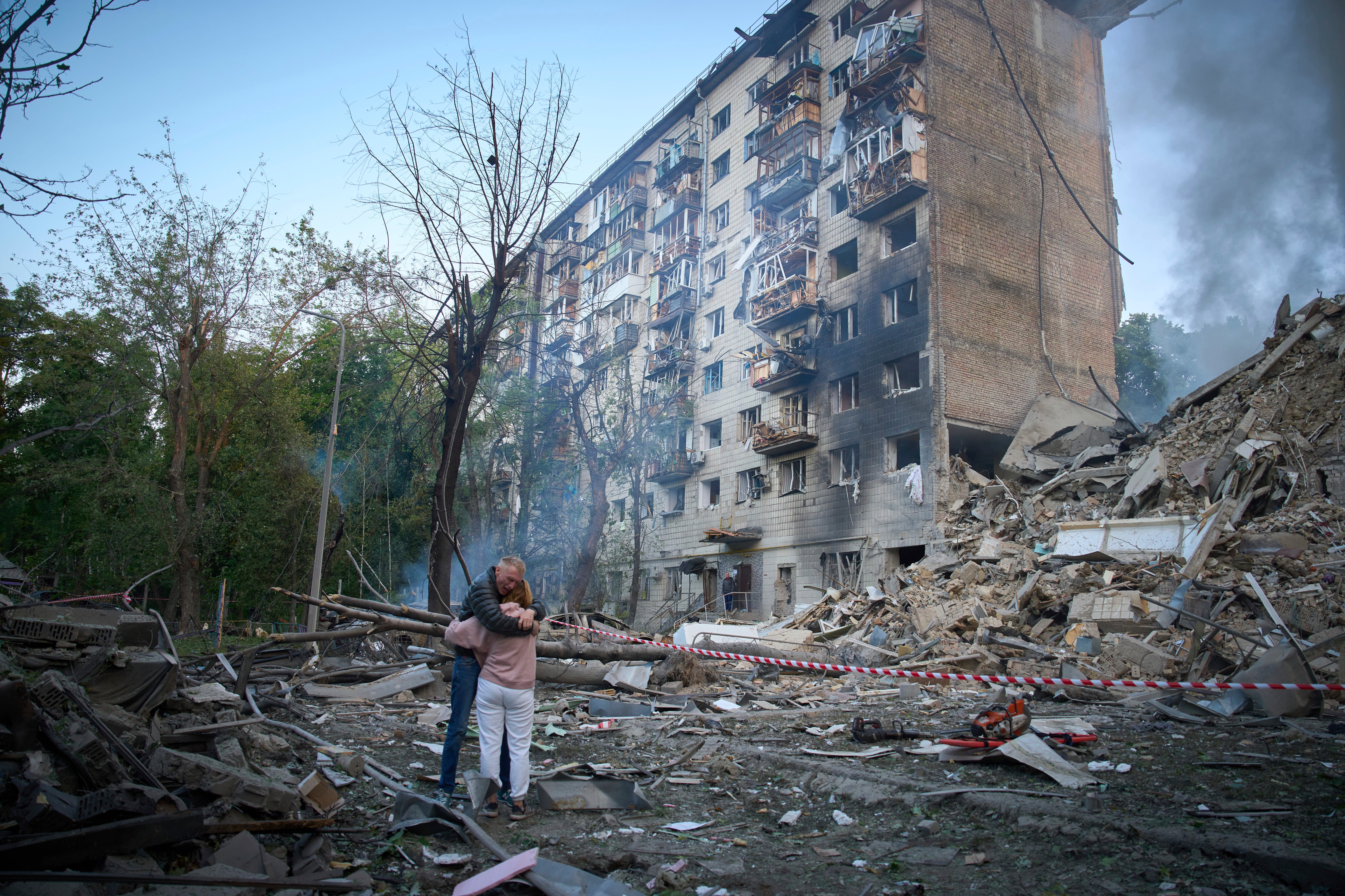 Residents embrace after a Russian missile hit a multi-storey apartment during Russia's combined missile and drone air attack in Kyiv, Ukraine, Tuesday, June 17, 2025