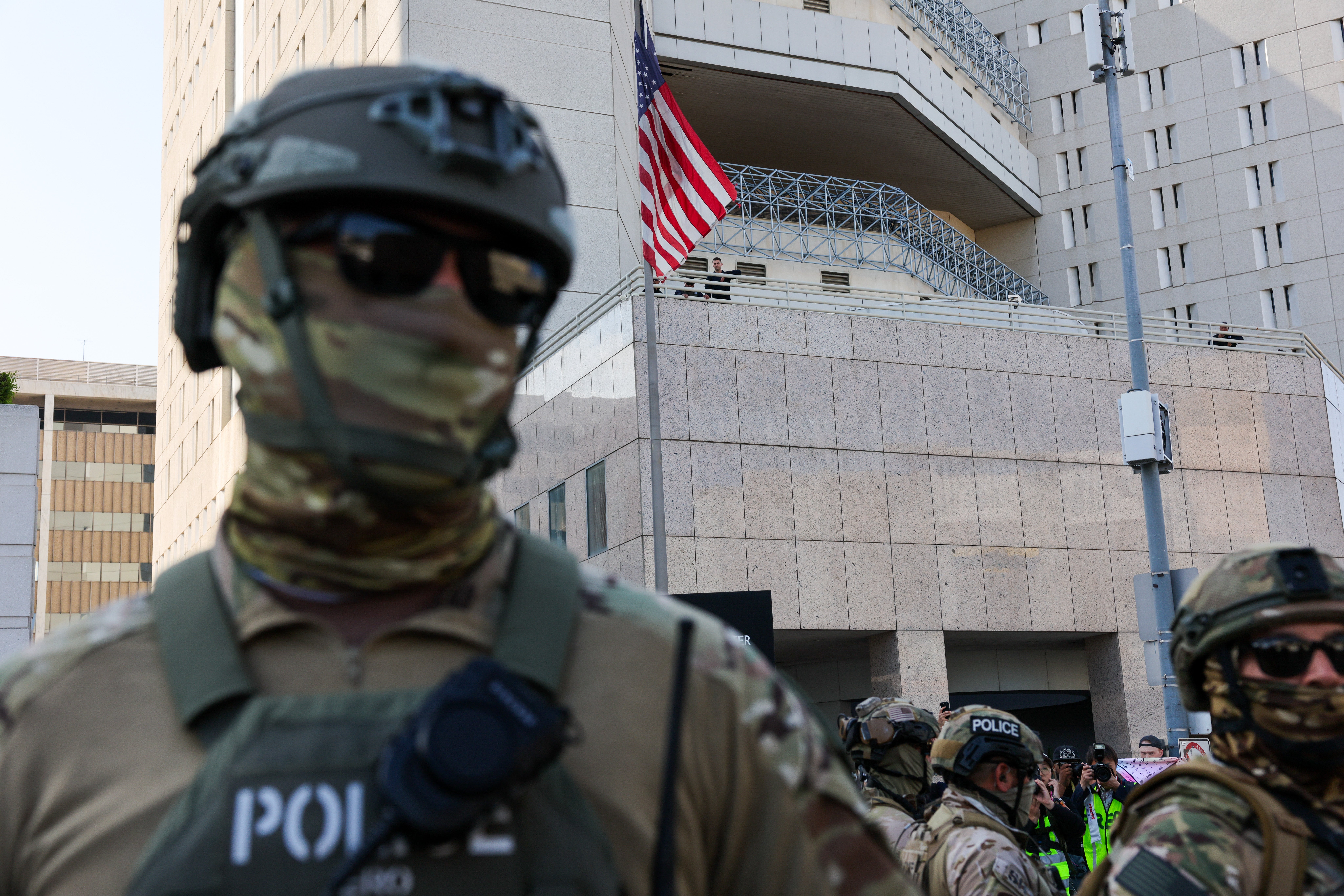 Federal agents guard an ICE detention center in downtown Los Angeles oin June