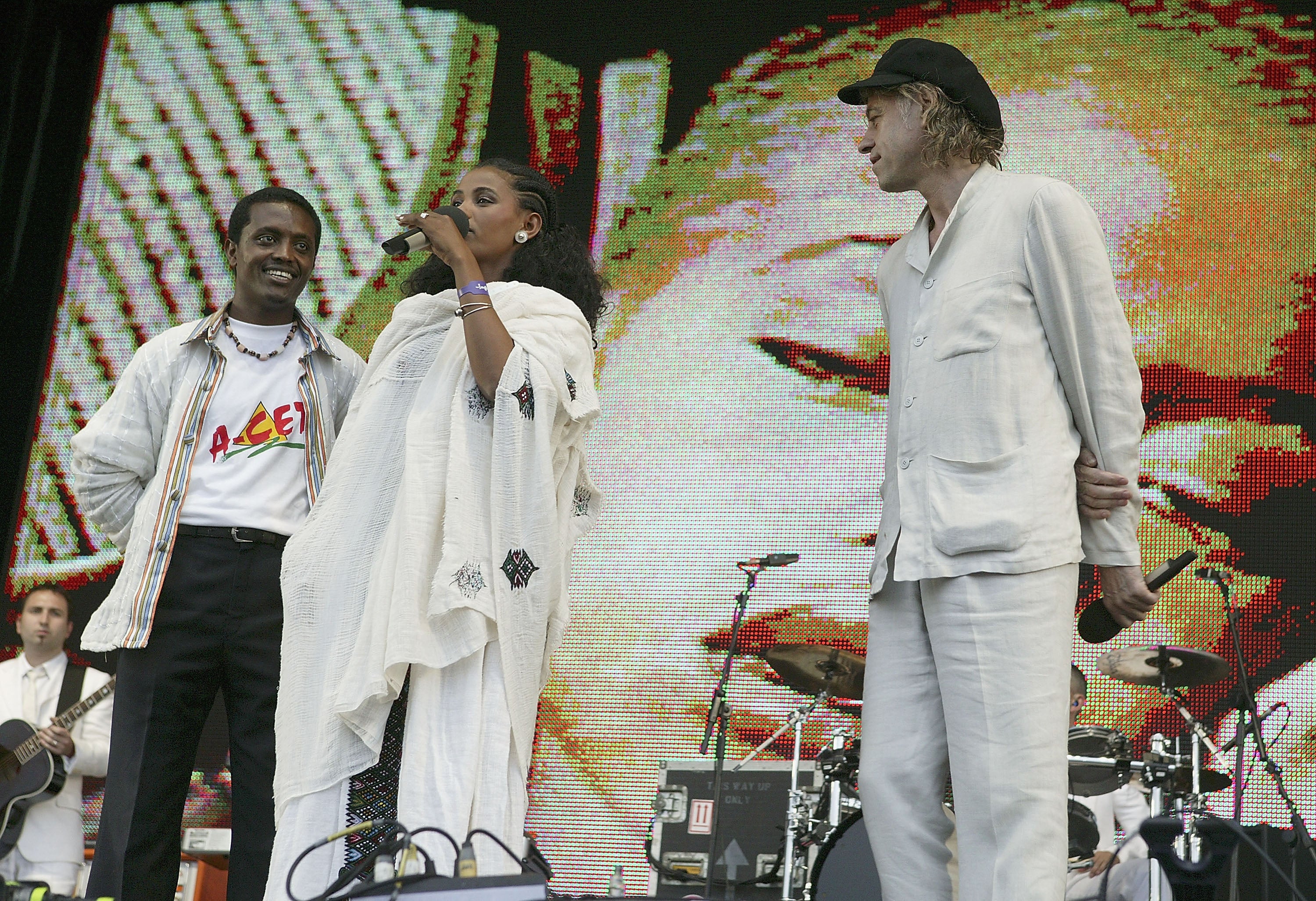 Twenty-four-year-old student Birhan Woldu, former Ethiopian famine victim and the inspiration for Live Aid 1985, speaks on stage as Bob Geldof looks on during Live 8 London