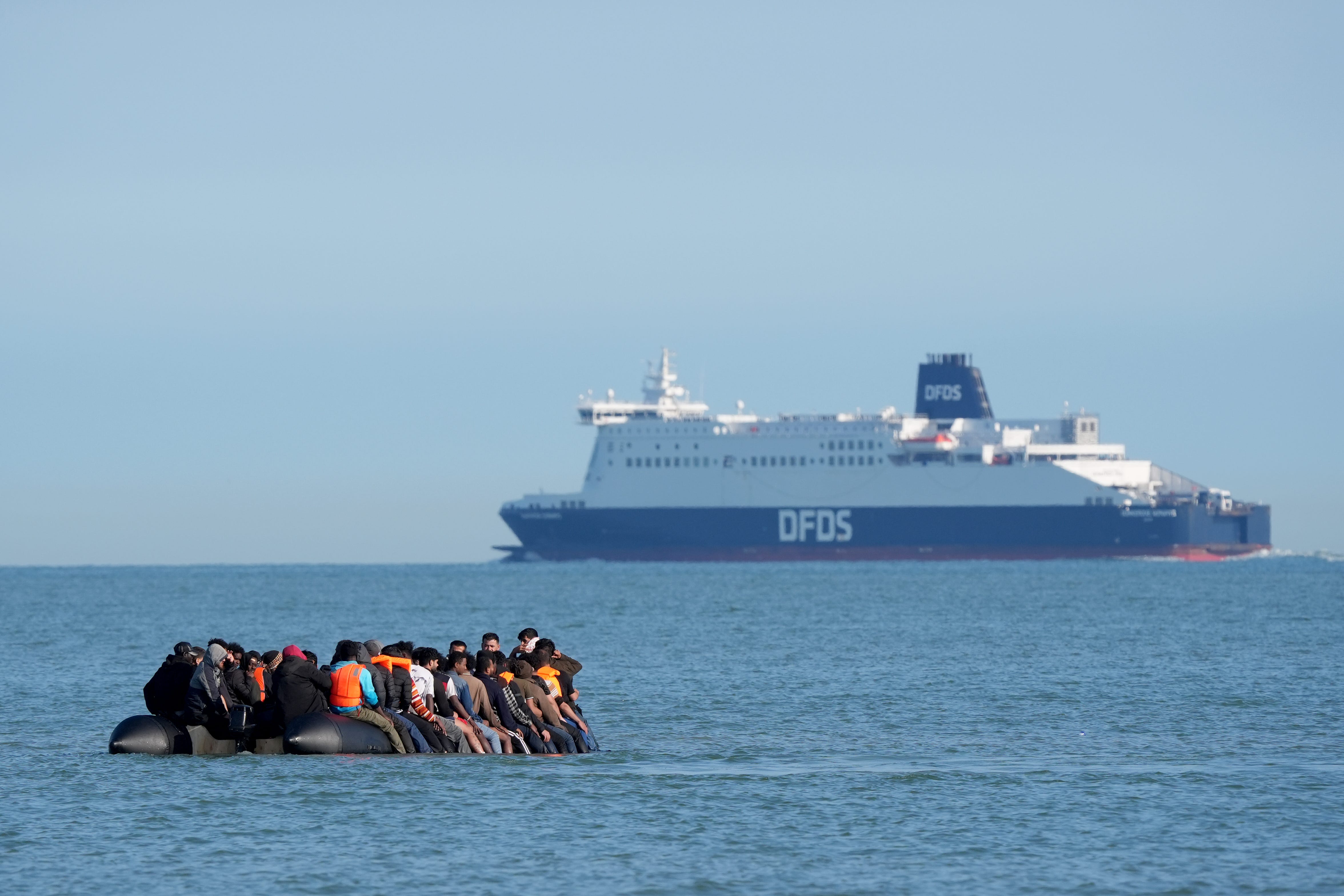 A group of people thought to be migrants on a dinghy near the beach at Gravelines, France (Gareth Fuller/PA)