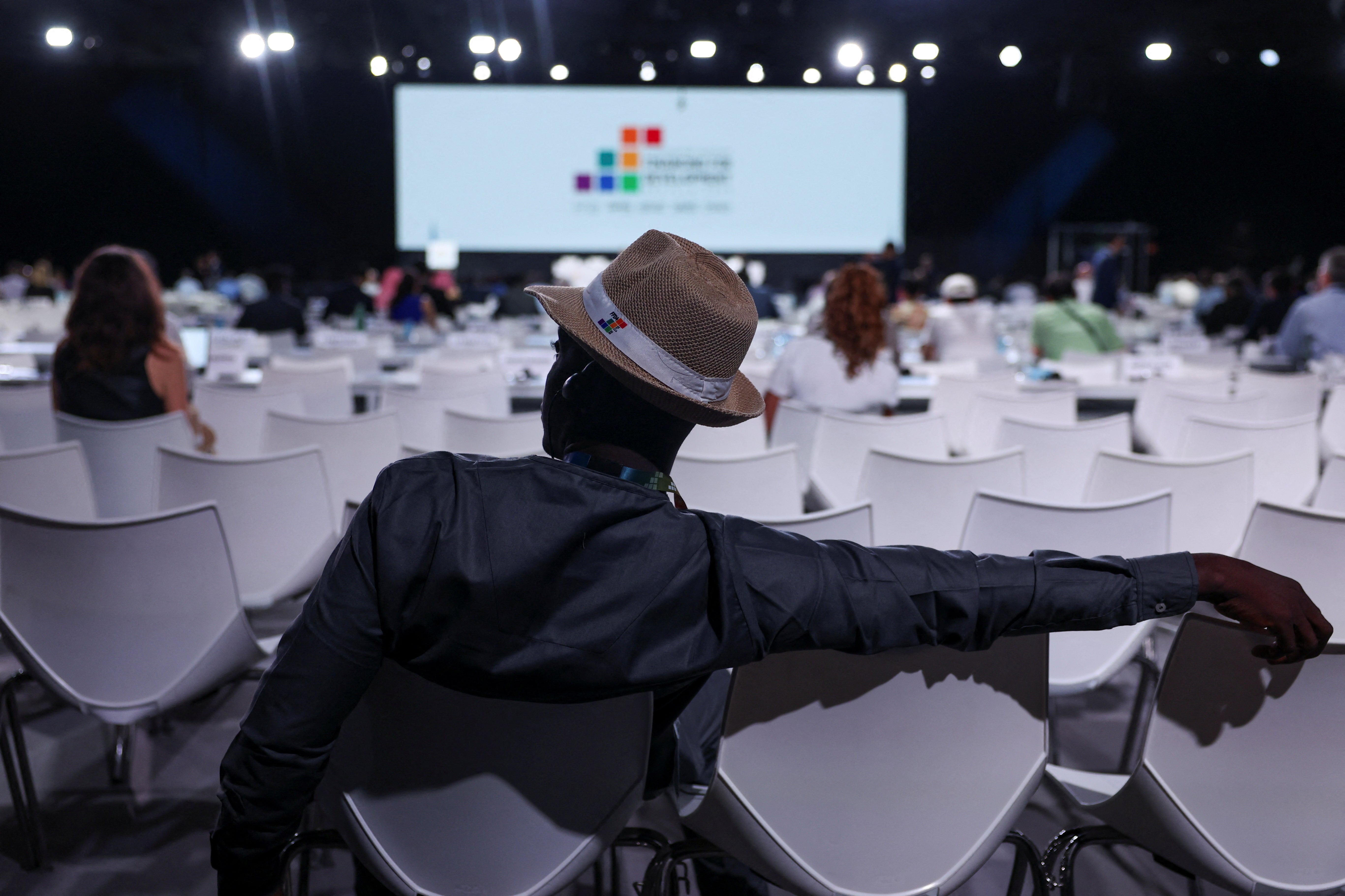 An attendee watches proceedings during the 4th International Conference on Financing for Development, in Seville, Spain