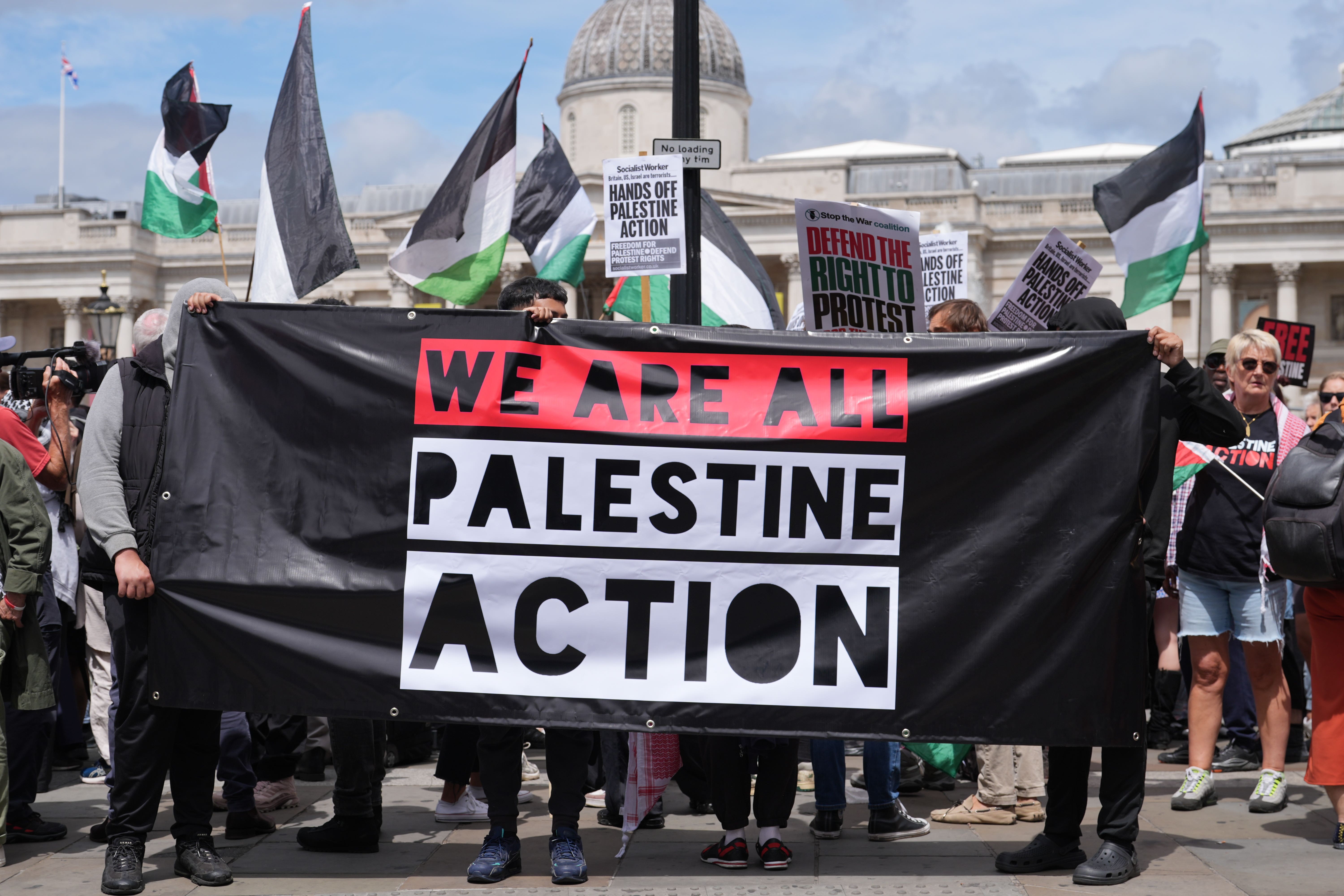 People take part in a demonstration at Trafalgar Square in London in support of Palestine Action (Lucy North/PA)