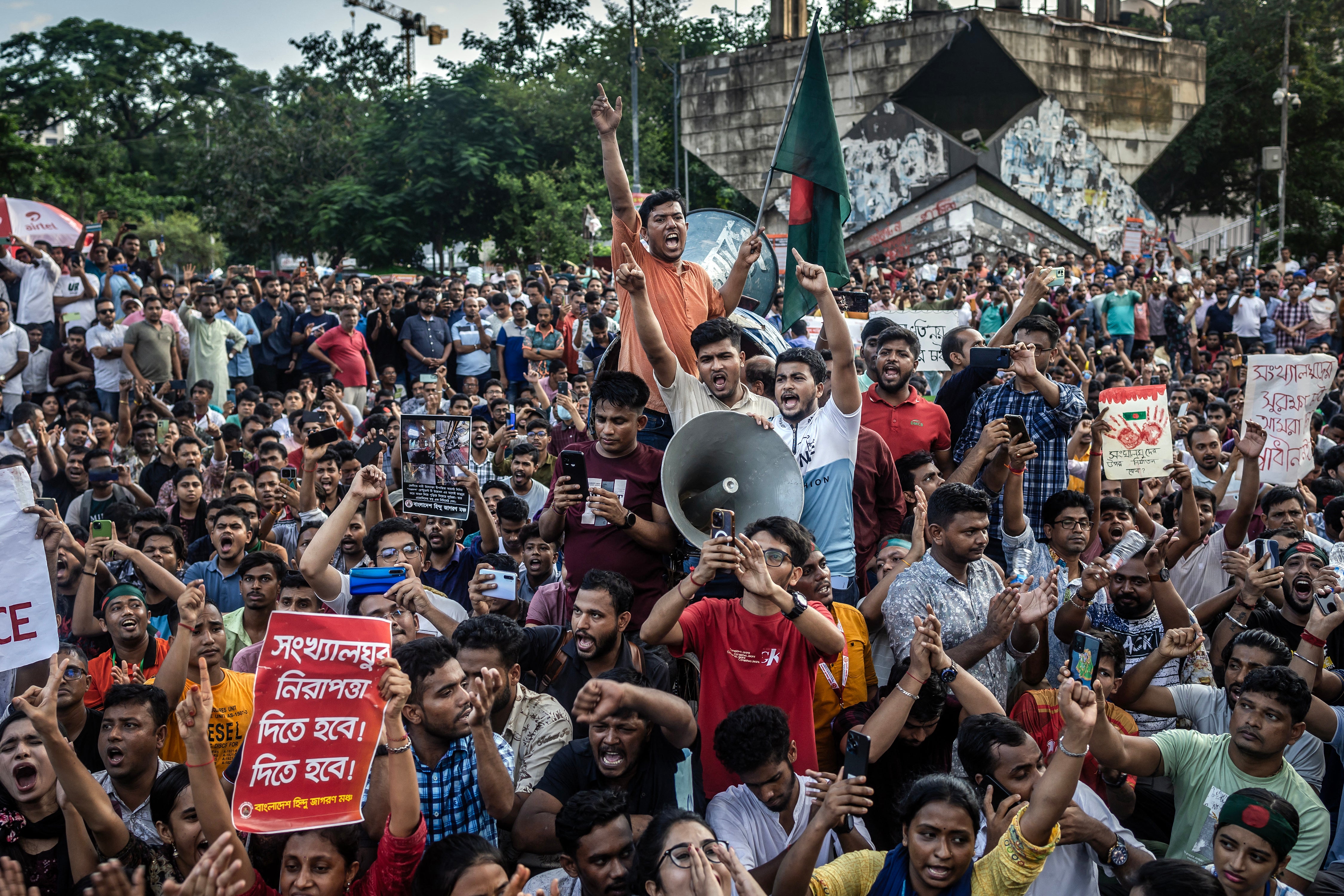 Members of the Bangladeshi Hindu community hold banners and chant slogans against violence targeting the country’s minorities during a protest in Dhaka on 9 August 2024
