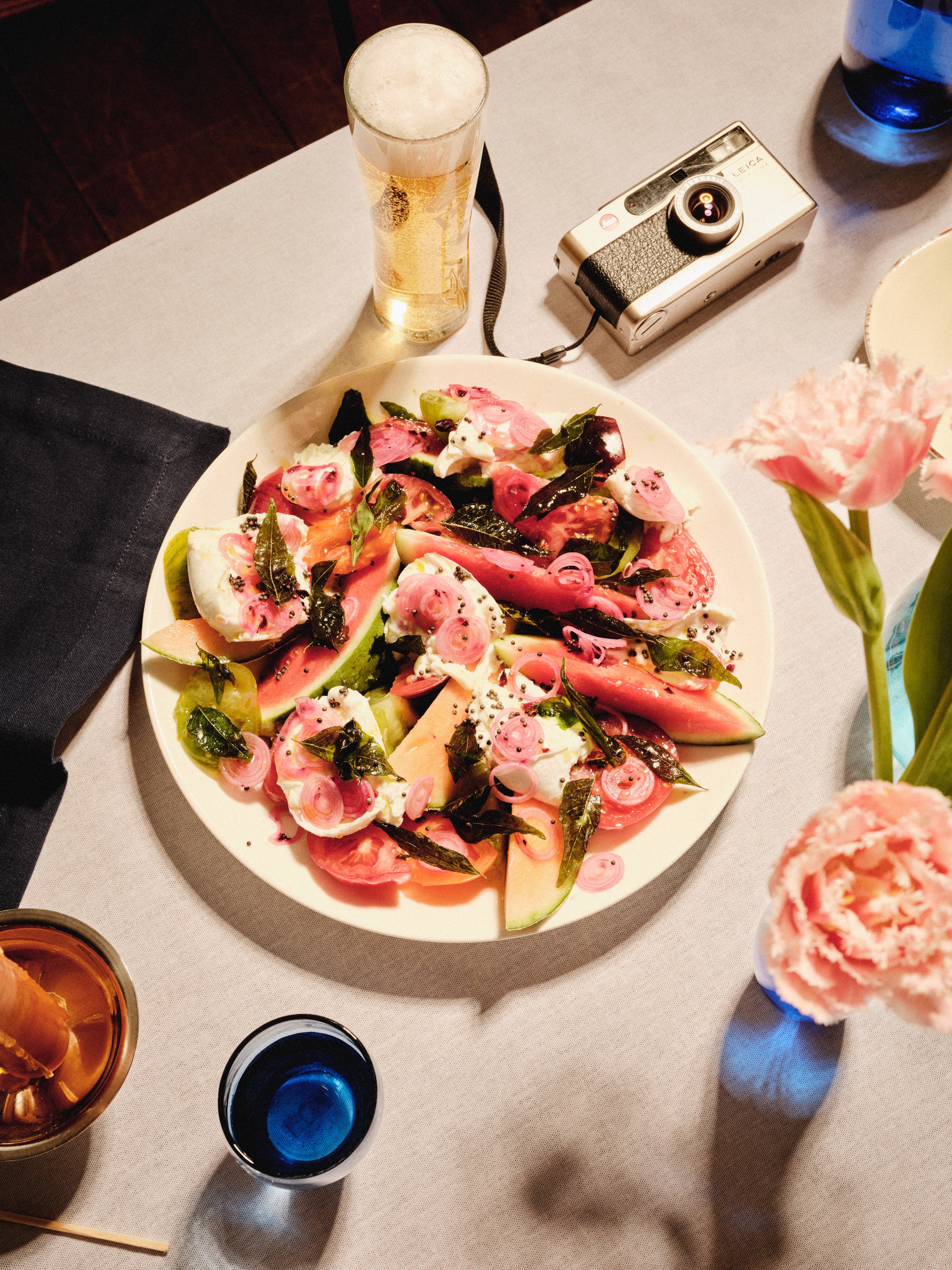 Capri’s sun-drenched simplicity gets the Ixta treatment: vibrant fruit, pickled shallots and crispy basil that crackles like summer itself