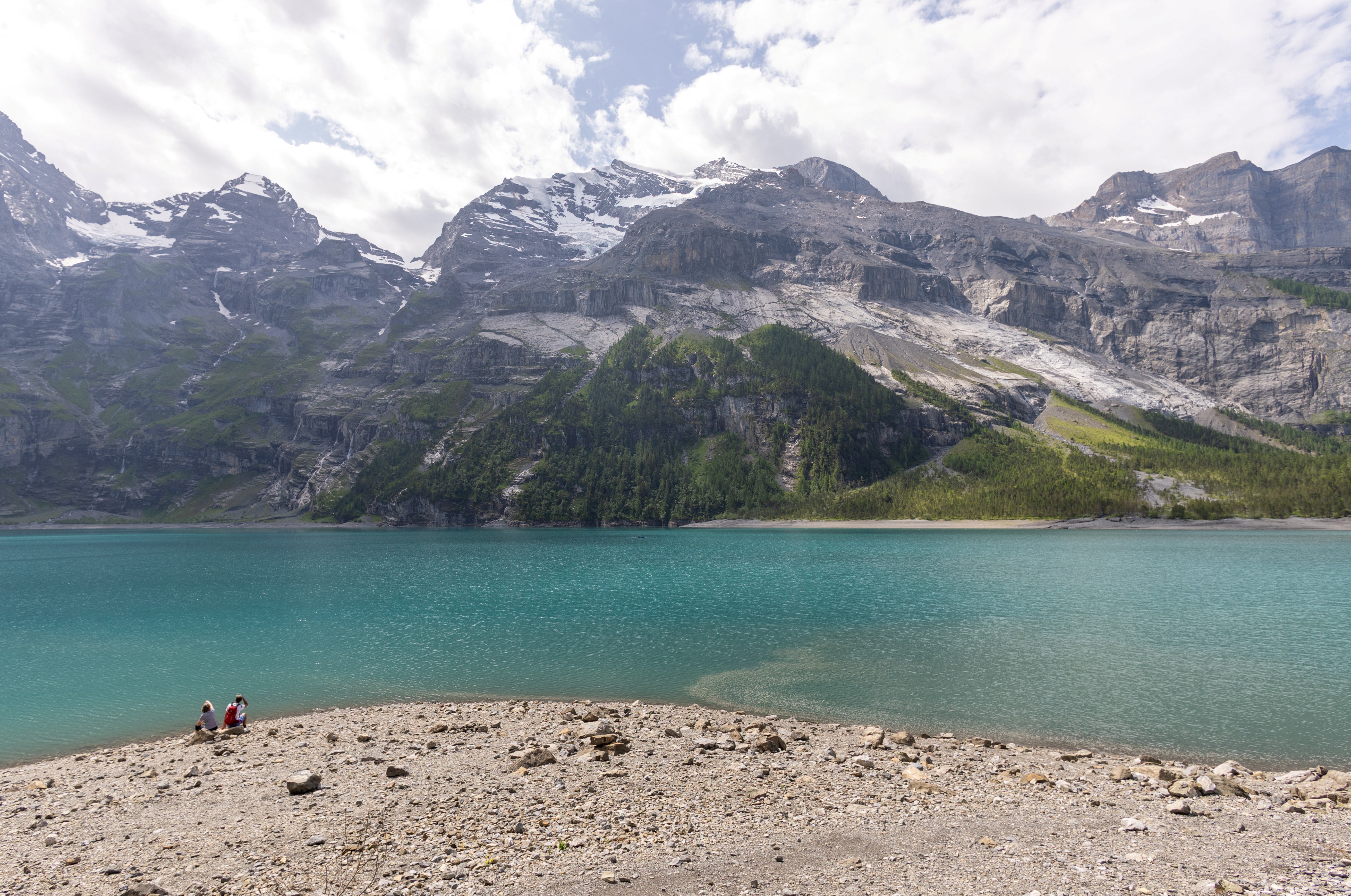 Hikers look a the Spitzen Stein at the Oeschinensee, as flash floods and rock falls threaten the village amid climate change and warming permafrost pose increasing challenges in Kandersteg, Switzerland, June 26, 2025
