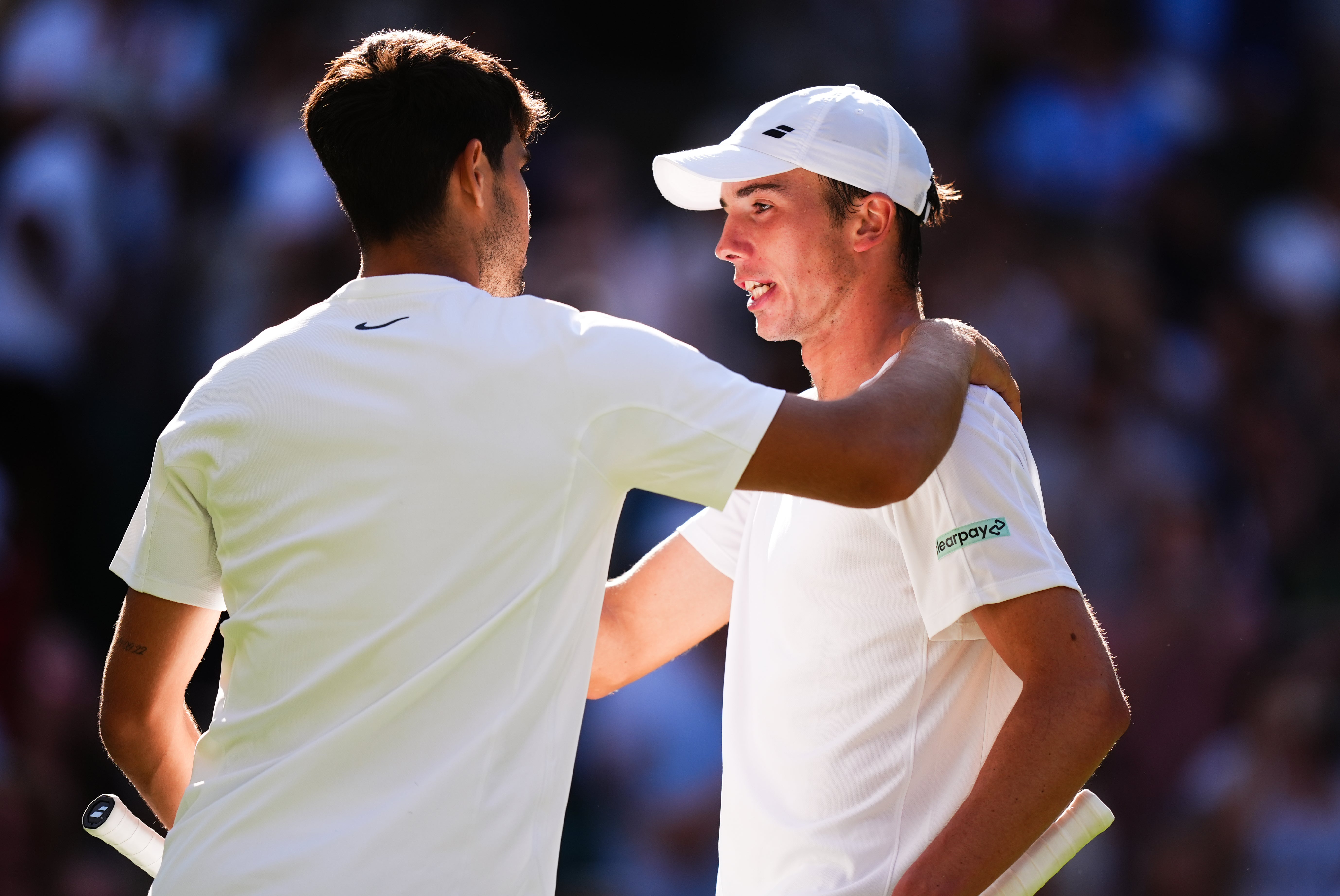 Carlos Alcaraz, left, congratulates Ollie Tarvet on his run to the second round of Wimbledon