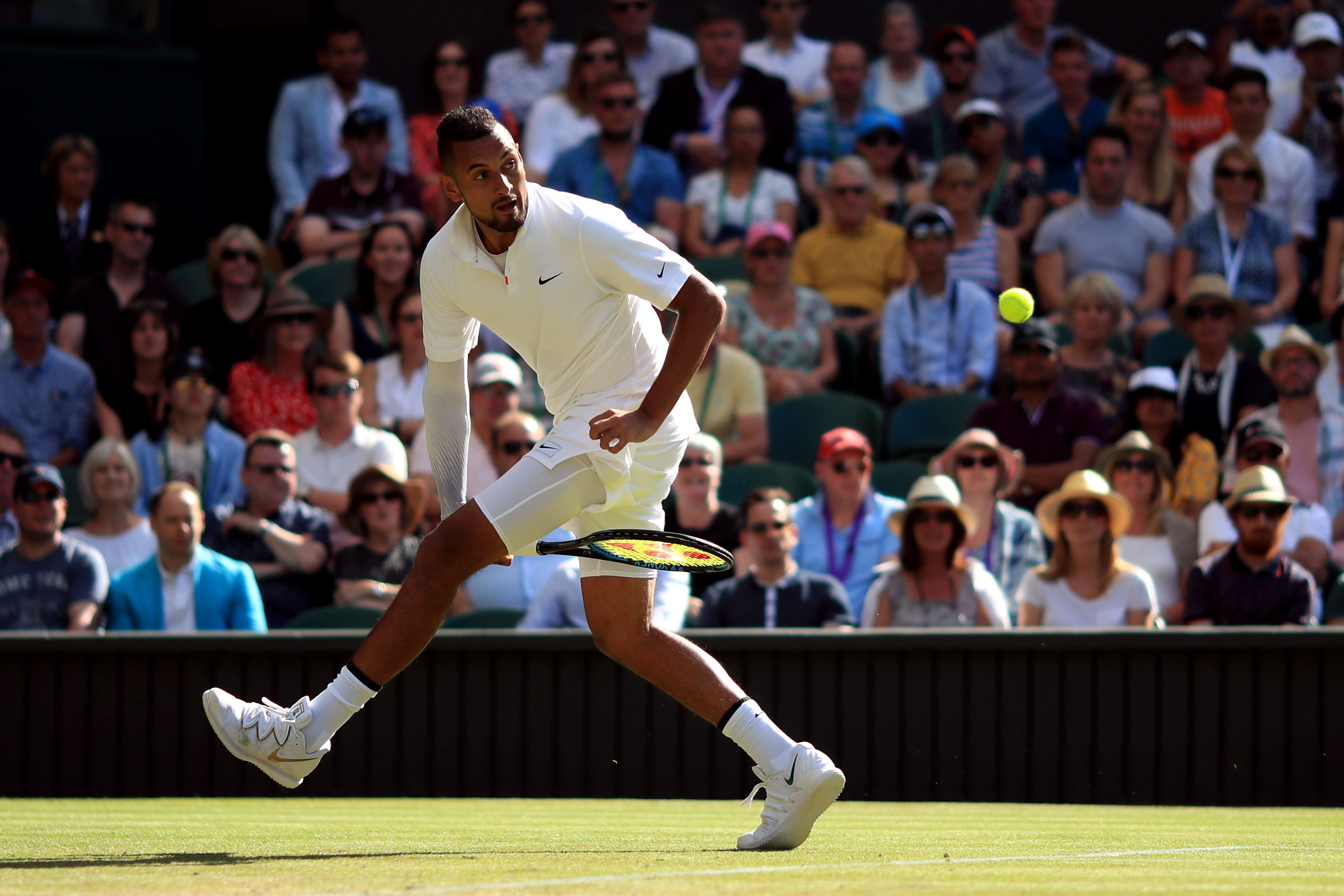 Nick Kyrgios plays a shot through his legs during his match against Rafael Nadal in 2019 (PA)