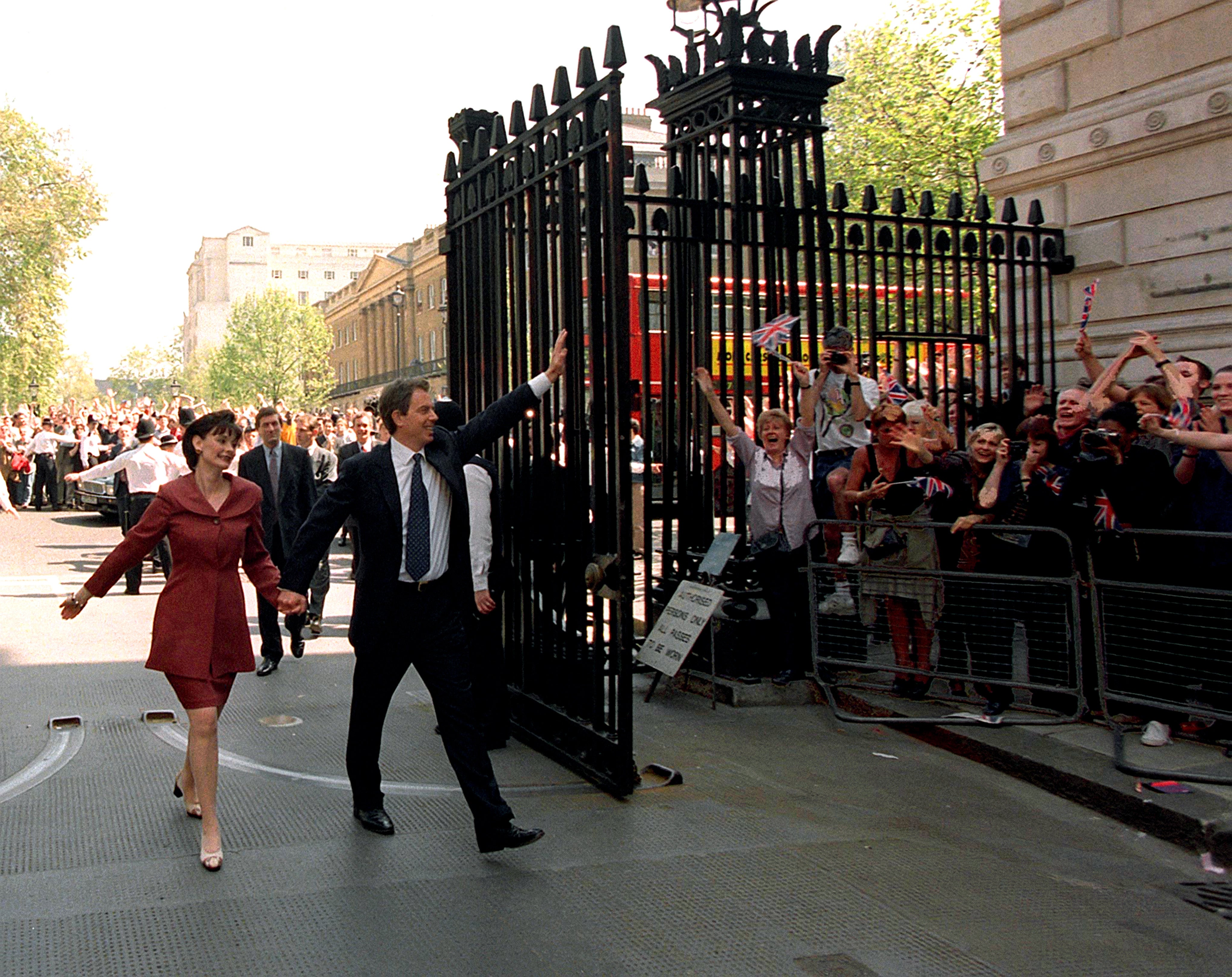 Tony Blair and his wife, Cherie, walk into Downing Street after Labour won the 1997 general election (Sean Dempsey/PA)