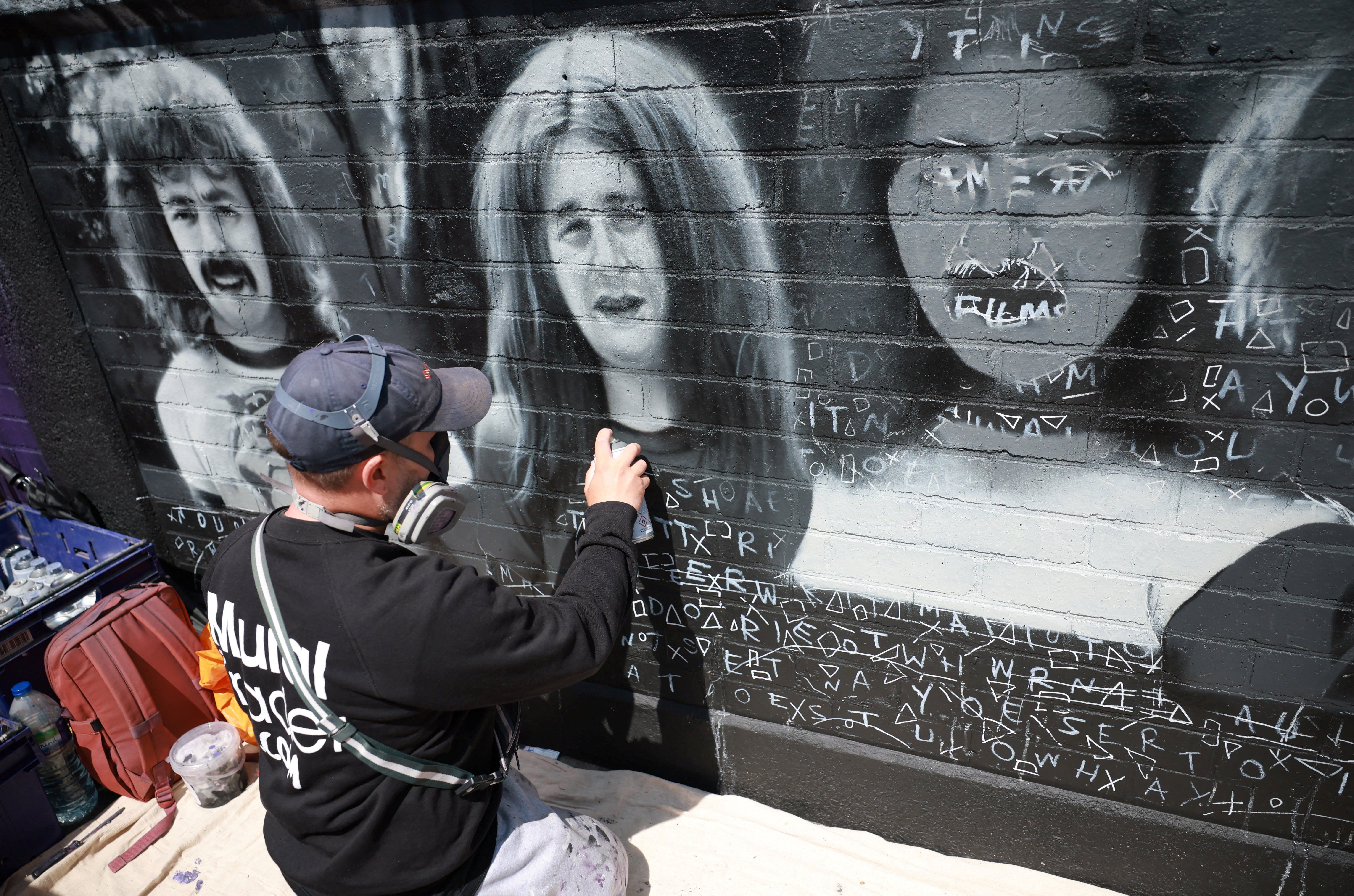 Artist Mr Murals prepares to work on his mural of rock band Black Sabbath ahead of their upcoming concert in Birmingham
