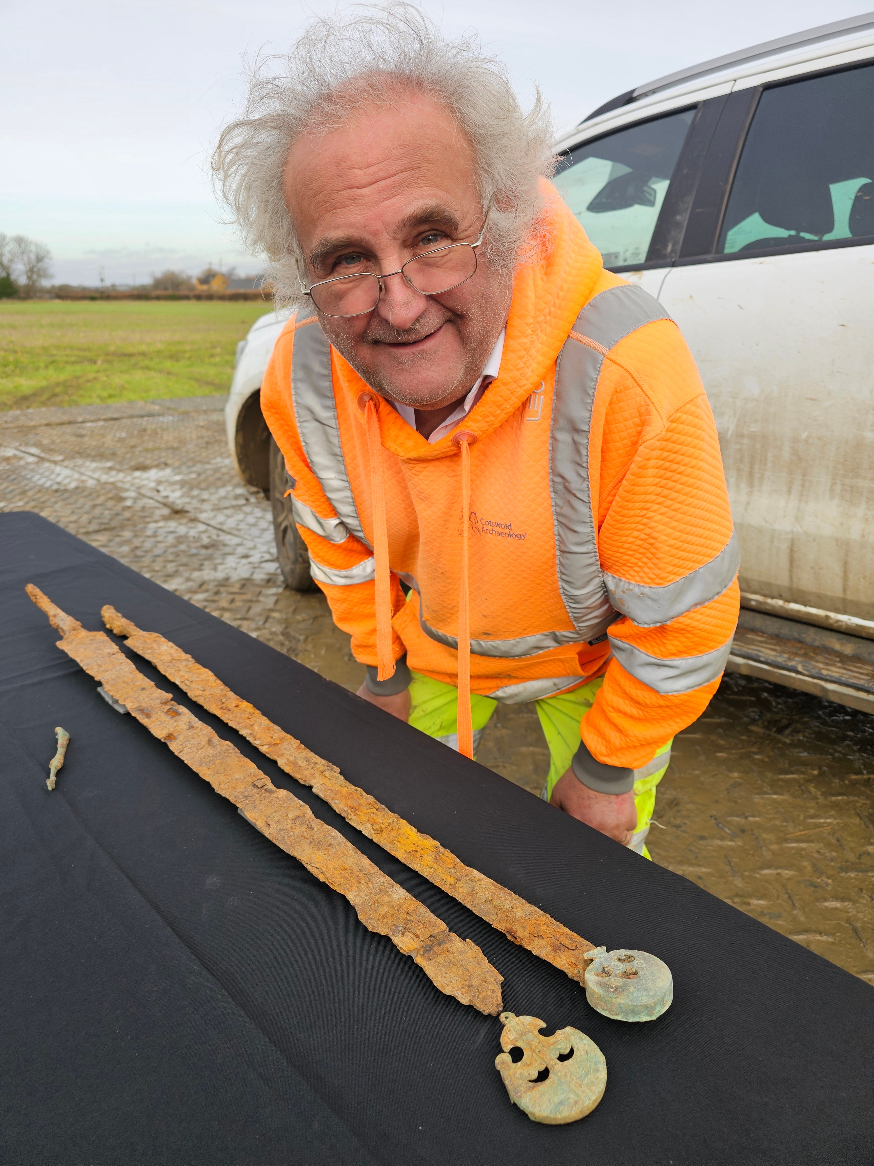Peter Busby with the two iron Roman cavalry swords, possibly displaying traces of their scabbards, found during a metal detecting rally near Willersey two years ago