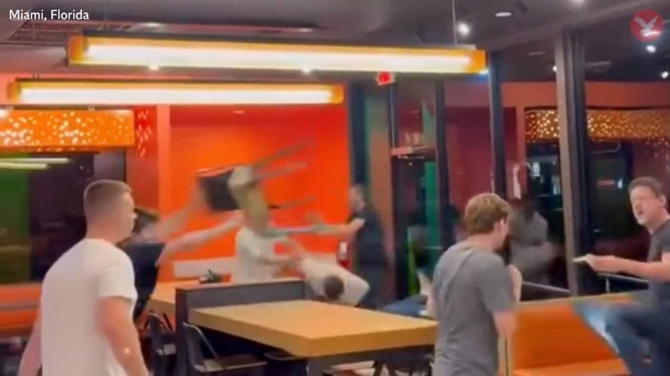 The customer has two chairs thrown at him