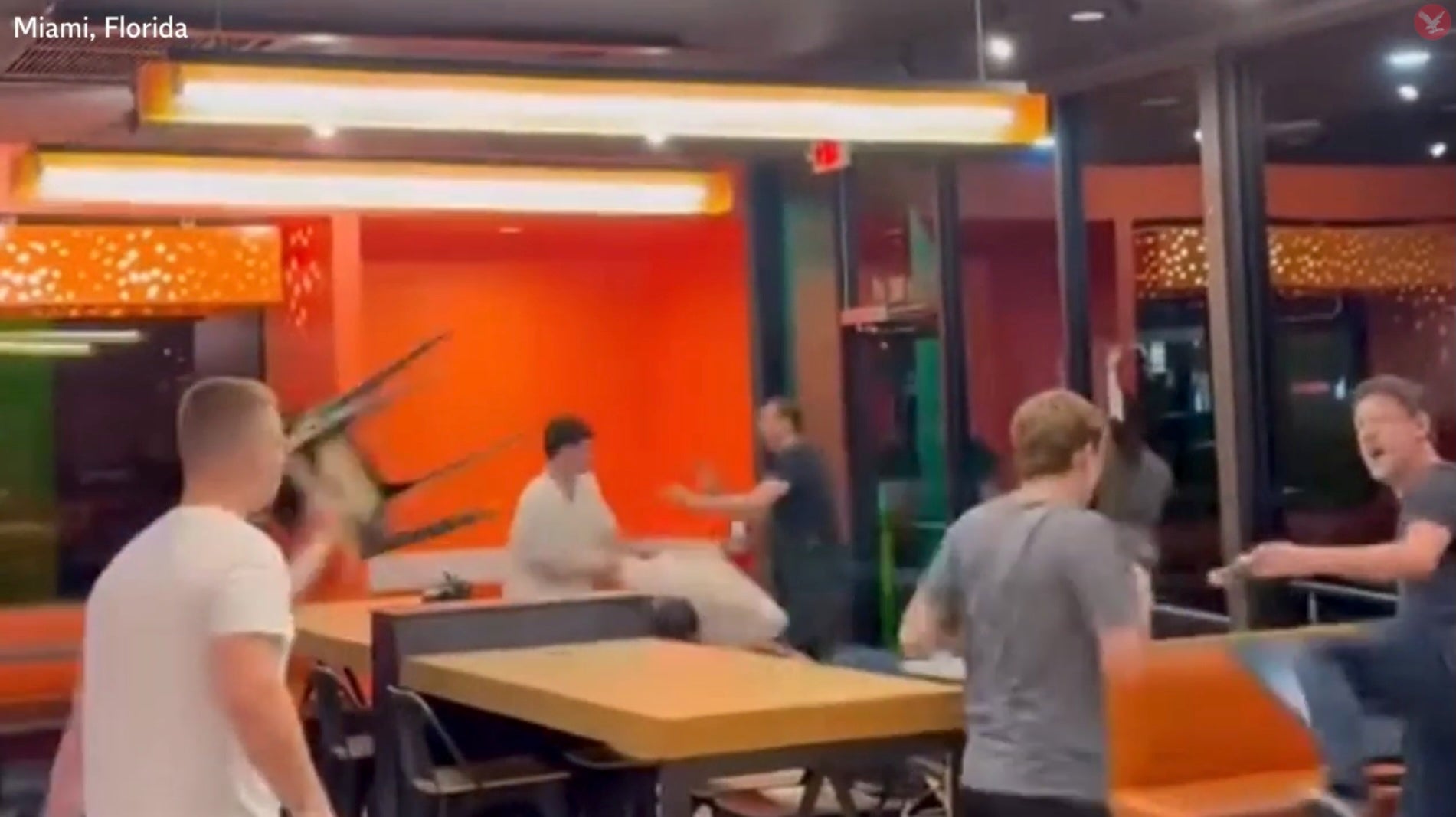 In the background of this fight, it appears another fight is taking place between four men