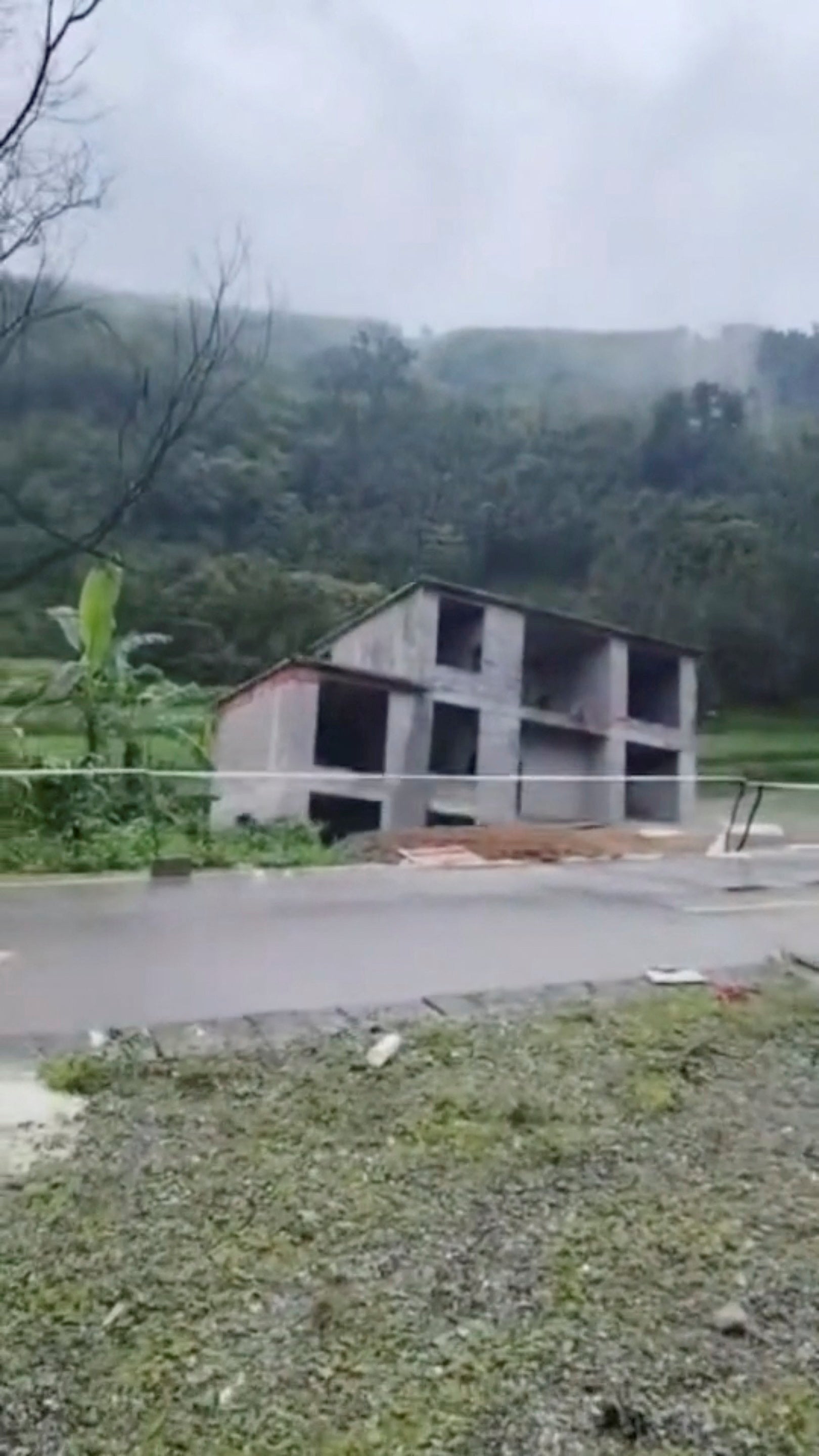 A building under construction collapses after the ground beneath it gives way following flooding of the Lengshui river in Xinzhou town of Guangxi Zhuang Autonomous Region