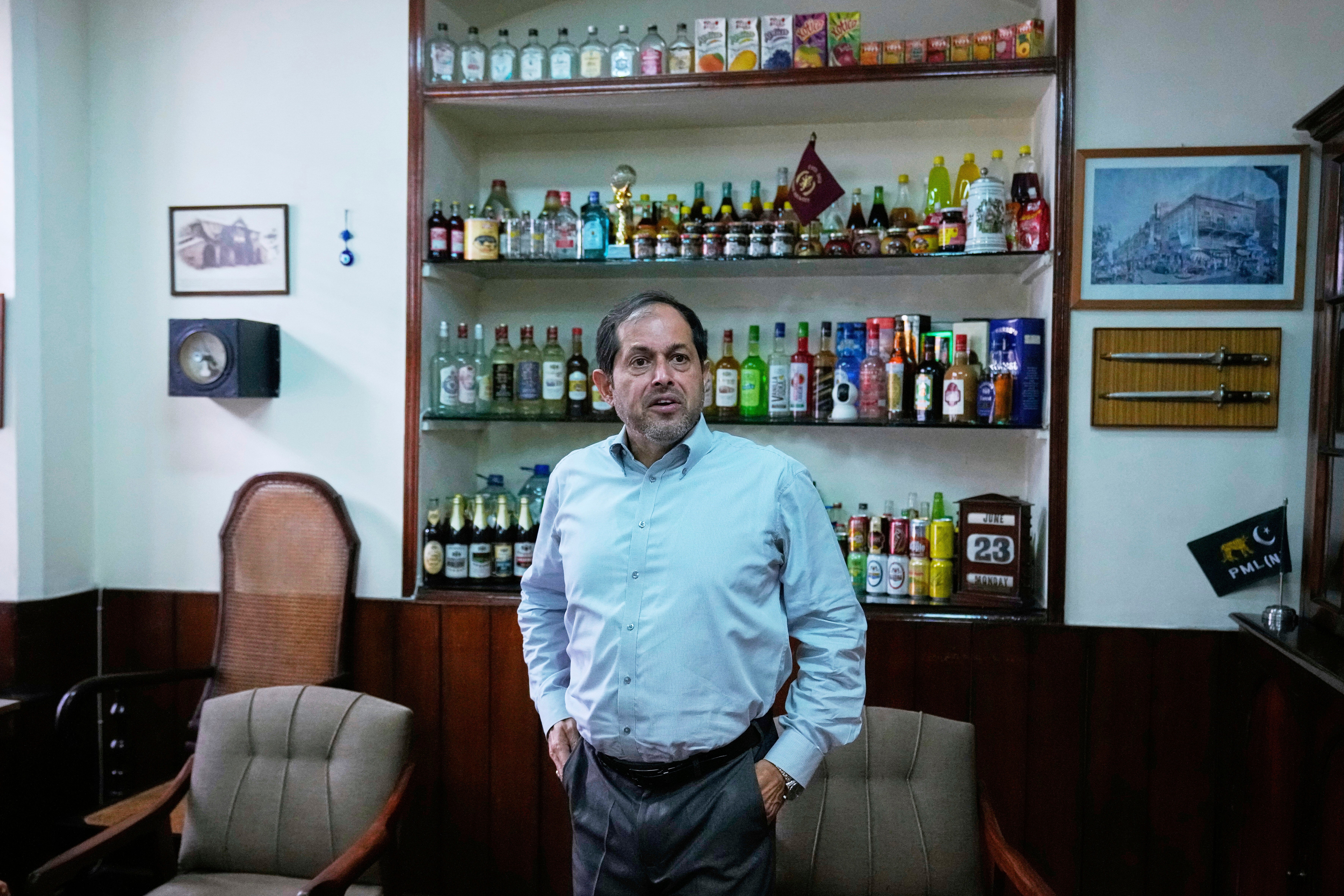 Isphanyar Bandhara, Chief Executive of the Murree Brewery talks with his assistant after an interview with The Associated Press, in Rawalpindi, Pakistan, Monday, June 23, 2025. (AP Photo/Anjum Naveed)