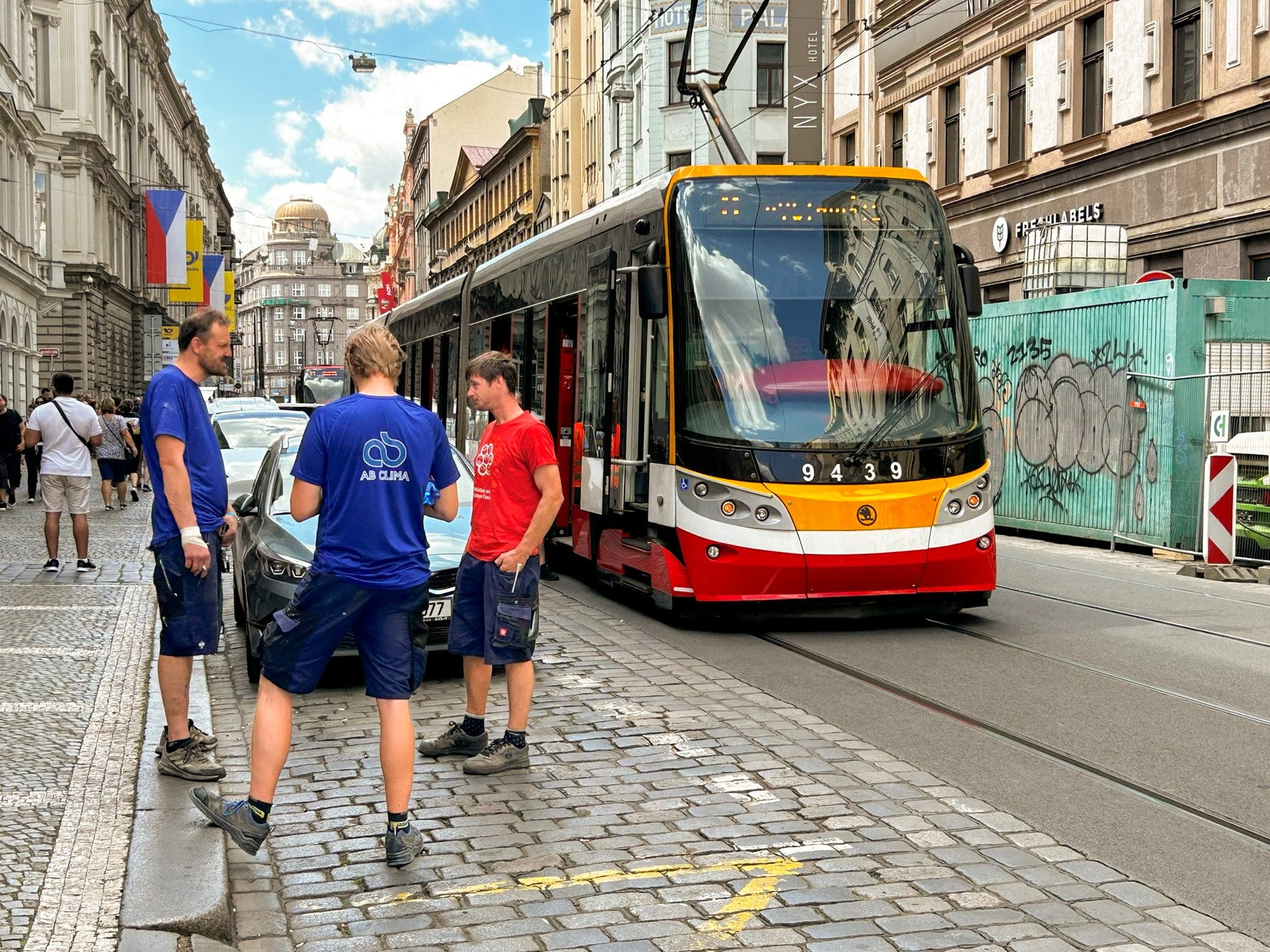 Men chat next to a stopped tram during a major power outage in Prague, Czech Republic, July 4, 2025