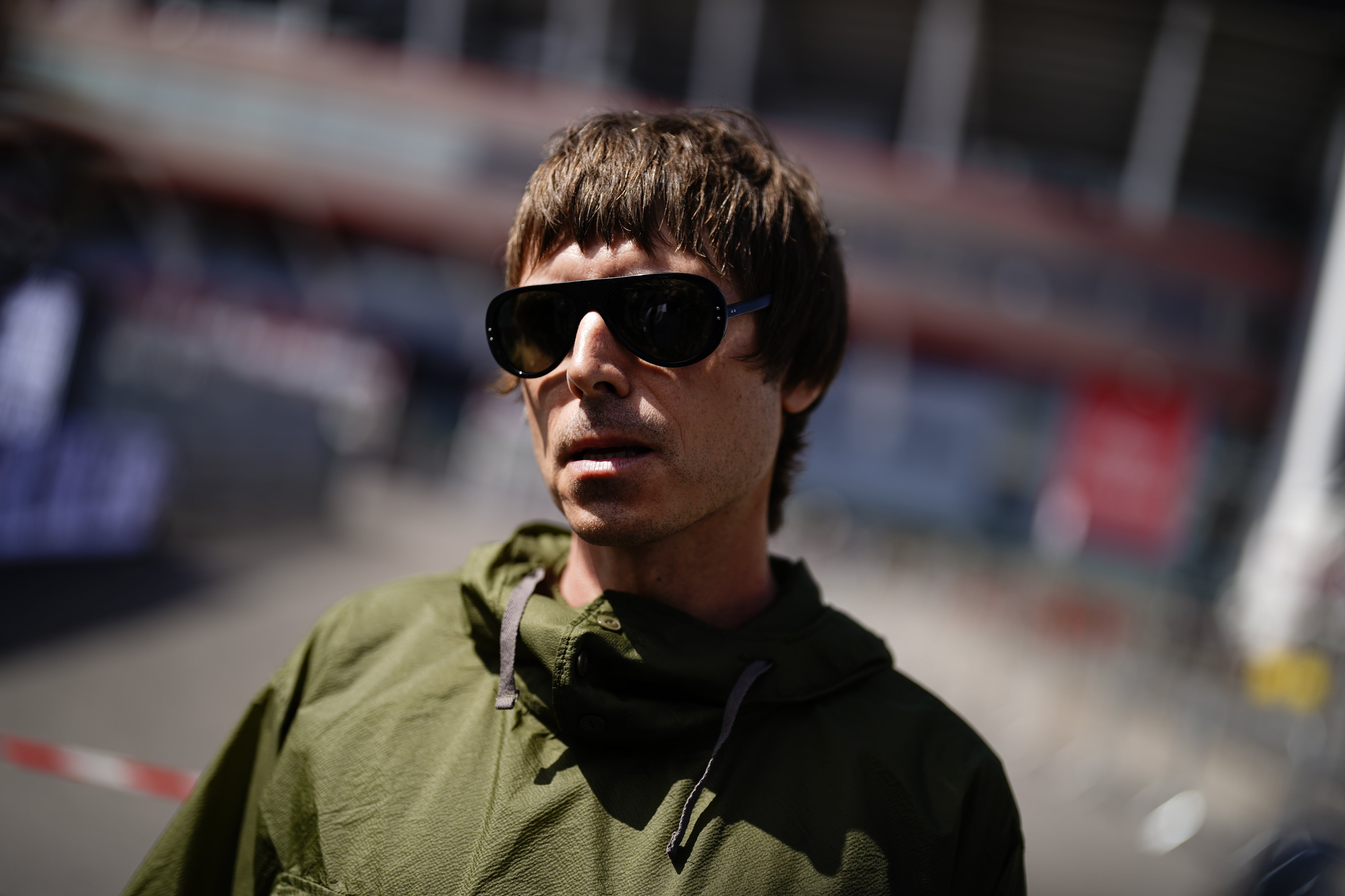 A Liam Gallagher lookalike wearing sunglasses and a green parka (Jordan Pettitt/PA)