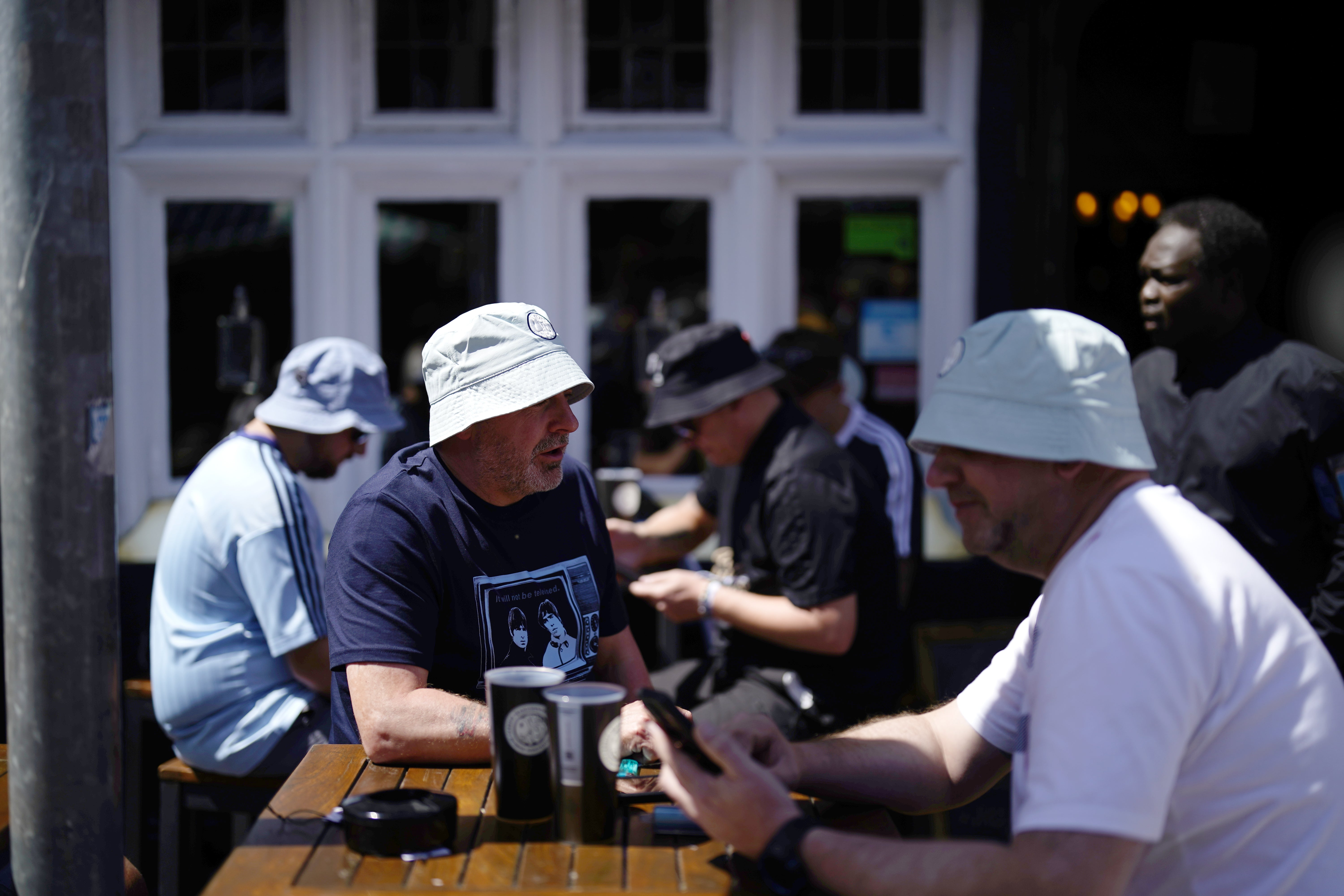No chance of any sunburn on the heads of these bucket hat wearing fans (Jordan Pettitt/PA)