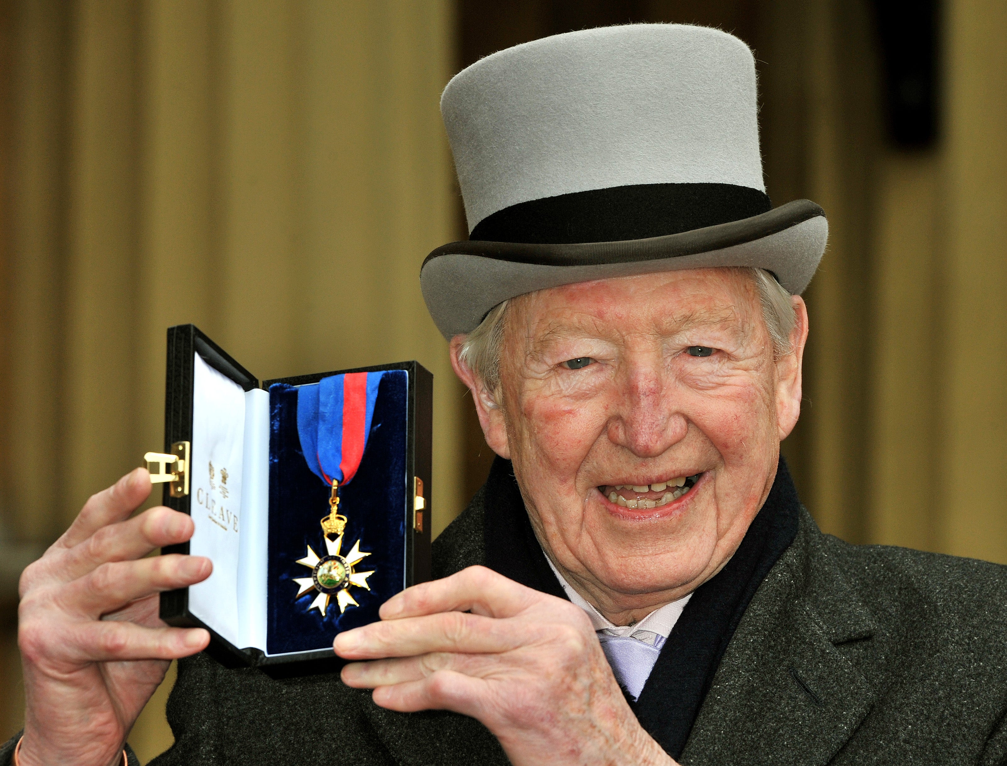 Sandy Gall during the 2011 investiture ceremony at Buckingham Palace