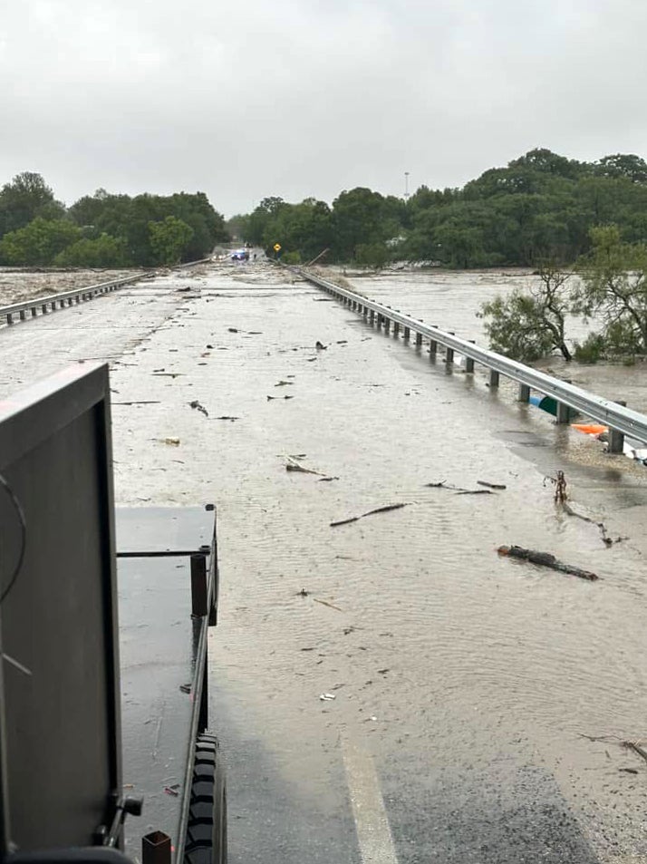 The Guadalupe River’s waters nearly crest the high-water bridge in Center Point. The river climbed to nearly 35 feet on Friday