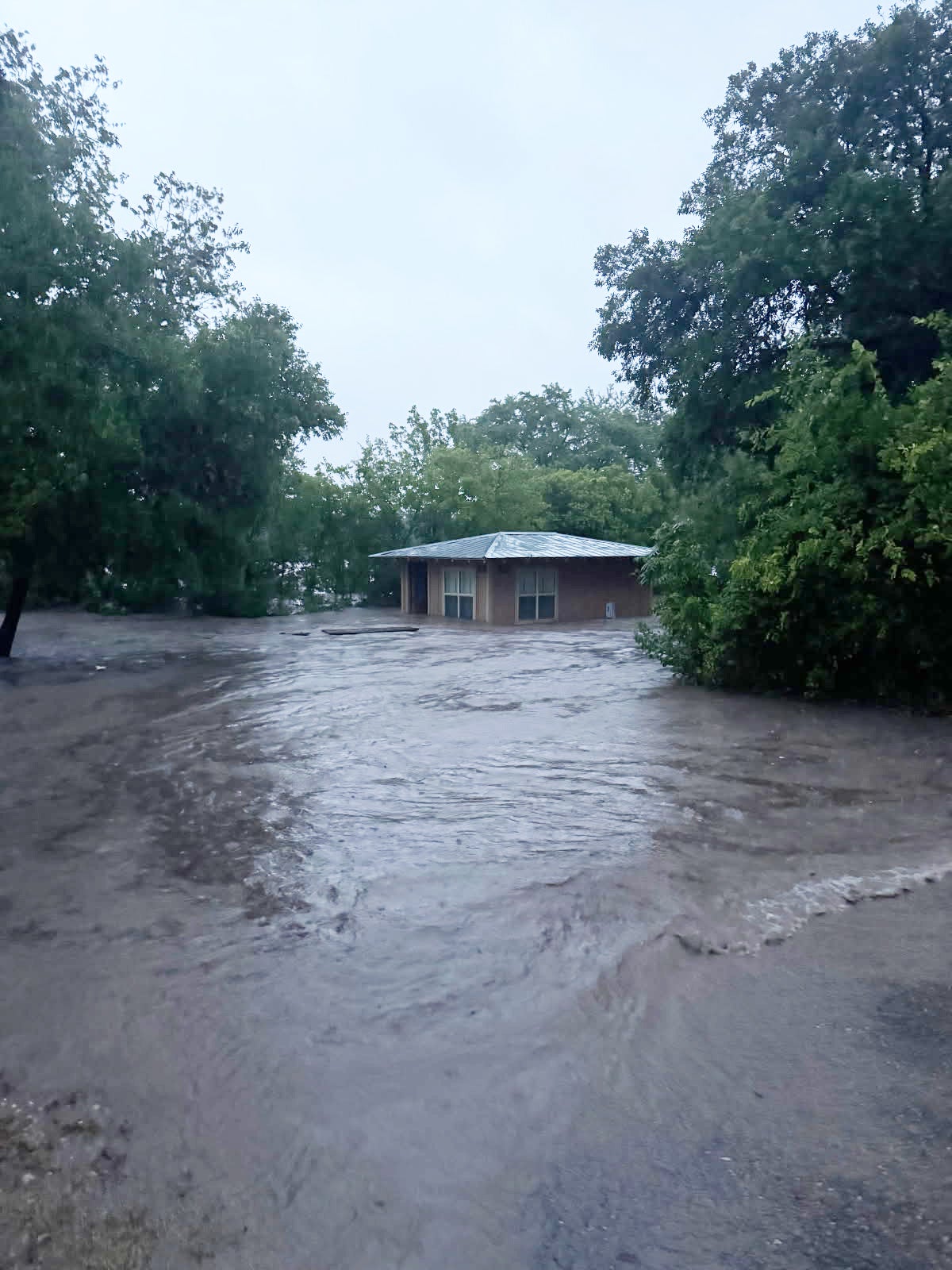 Local park entrances were flooded in Kerrville. Officials said dozens of rescues had been conducted