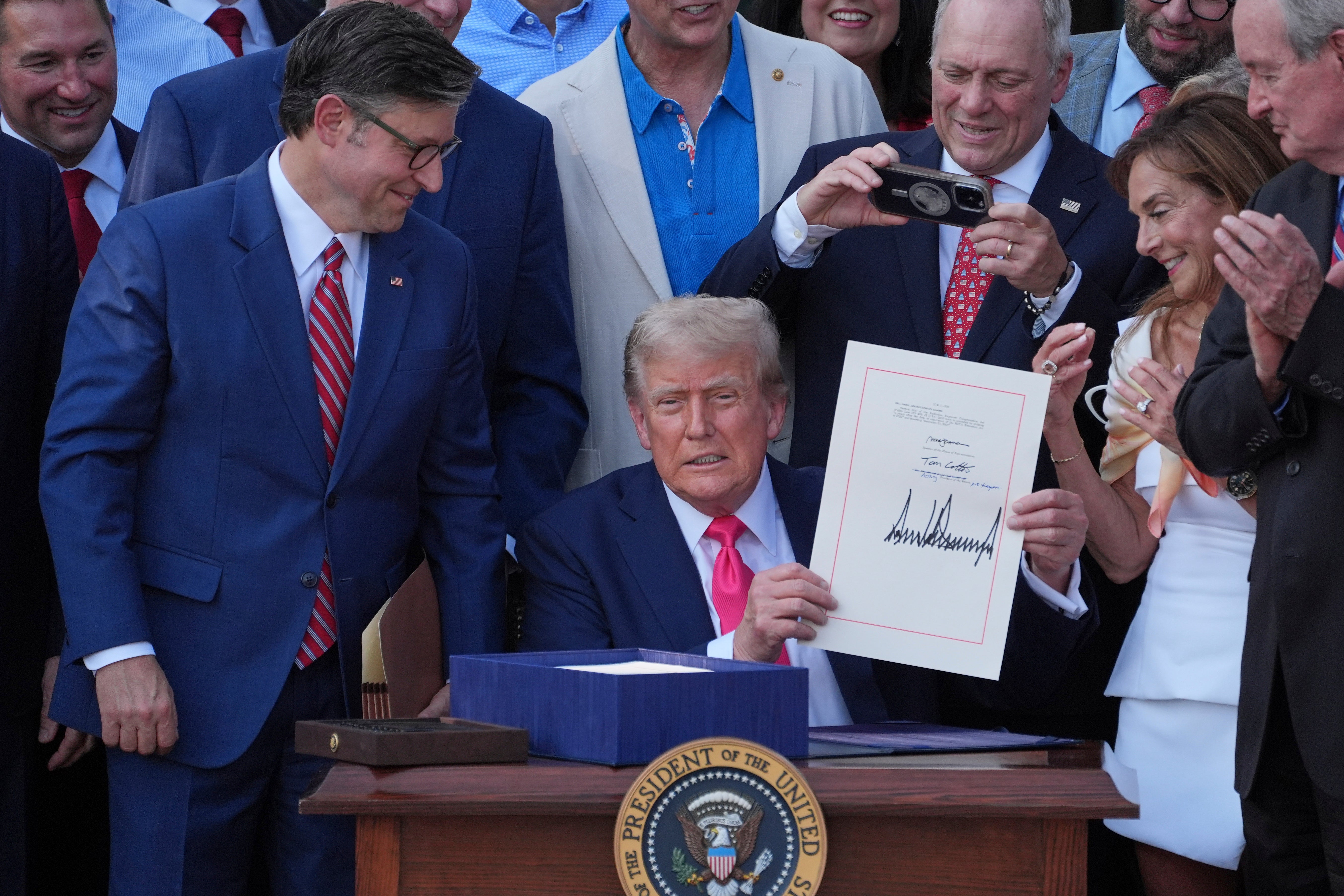President Donald Trump holds the 'Big, Beautiful Bill' after signing it on the White House's South Lawn