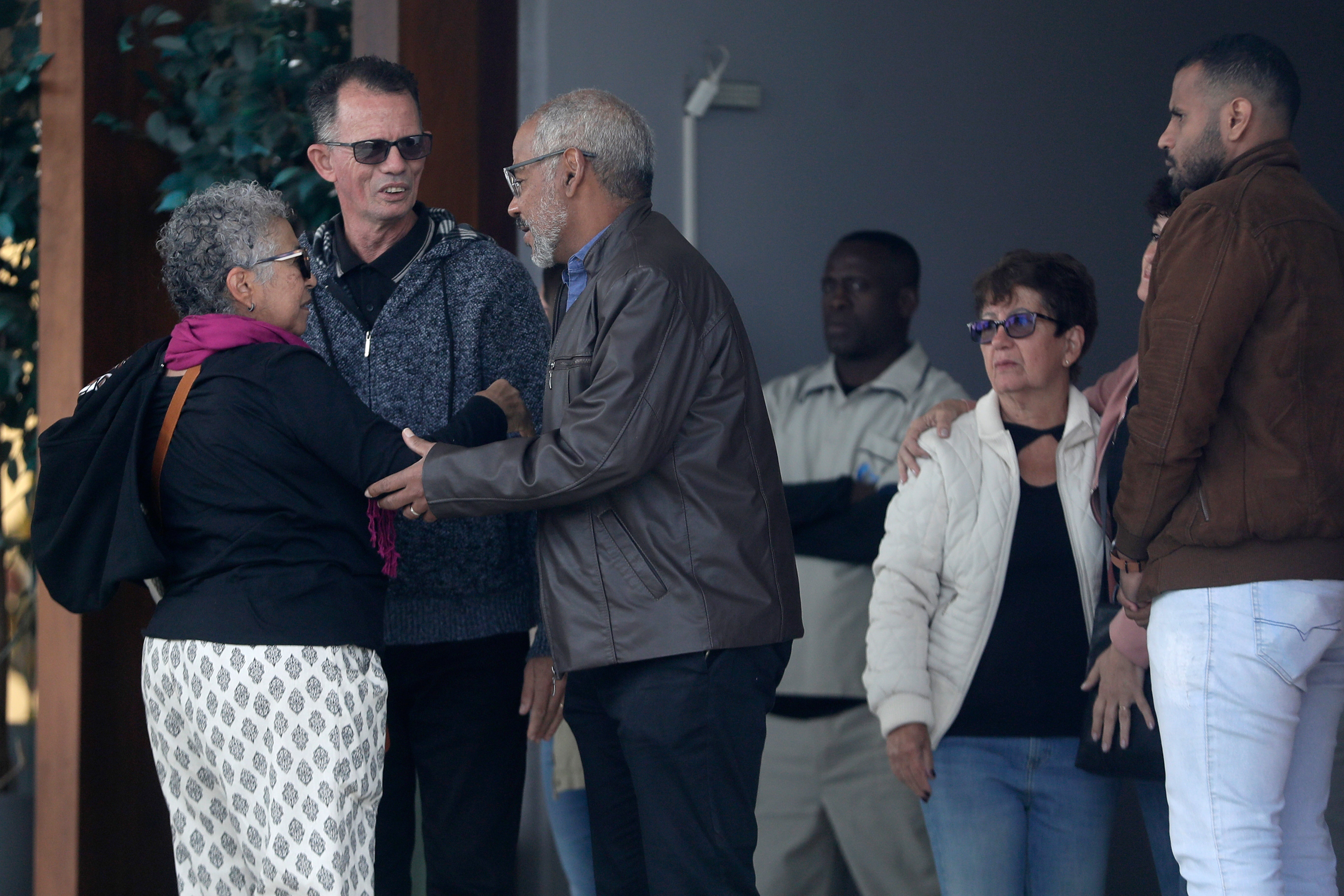 Manoel Marins (center) and Estela Marins (left) during the funeral for their daughter Juliana Marins, who died after falling from the summit of Mount Rinjani in Indonesia