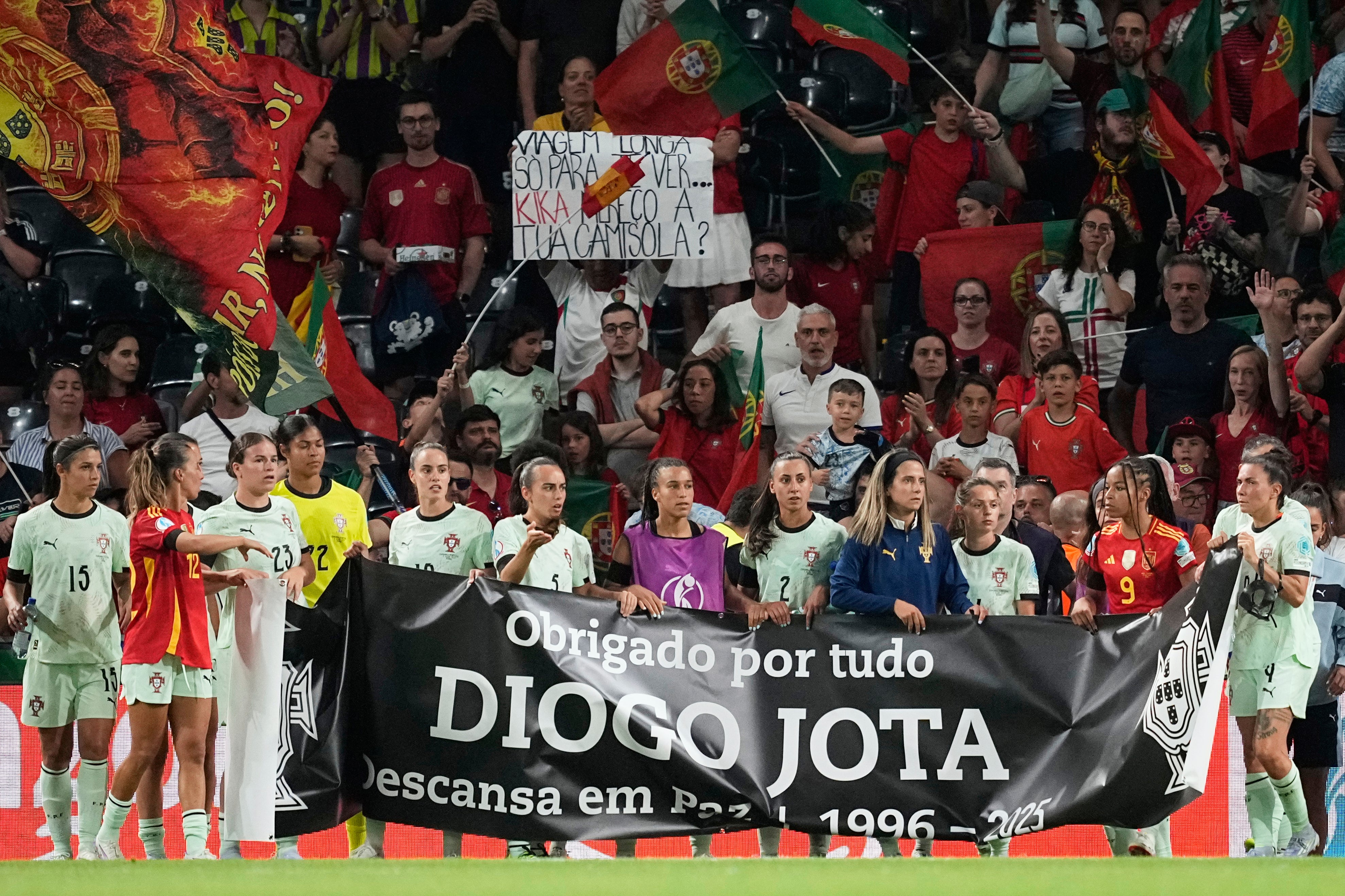 Portugal players hold a banner in memory of Portuguese international footballer Diogo Jota at the end of the Euro 2025match between Spain and Portugal