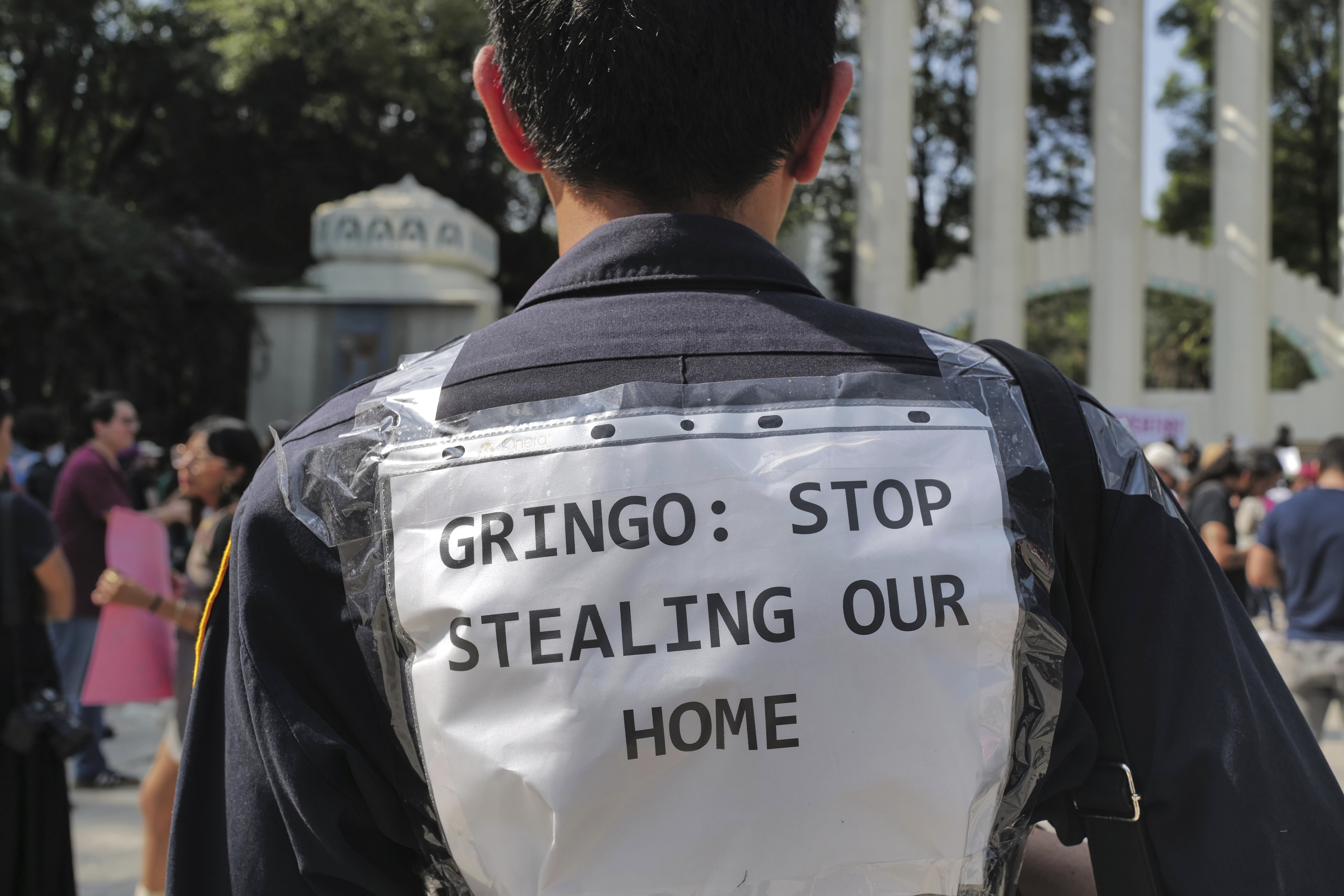 People protest against Americans' gentrification of parts of Mexico City, at Parque Mexico, Friday, July 4, 2025. (AP Photo/Jon Orbach)