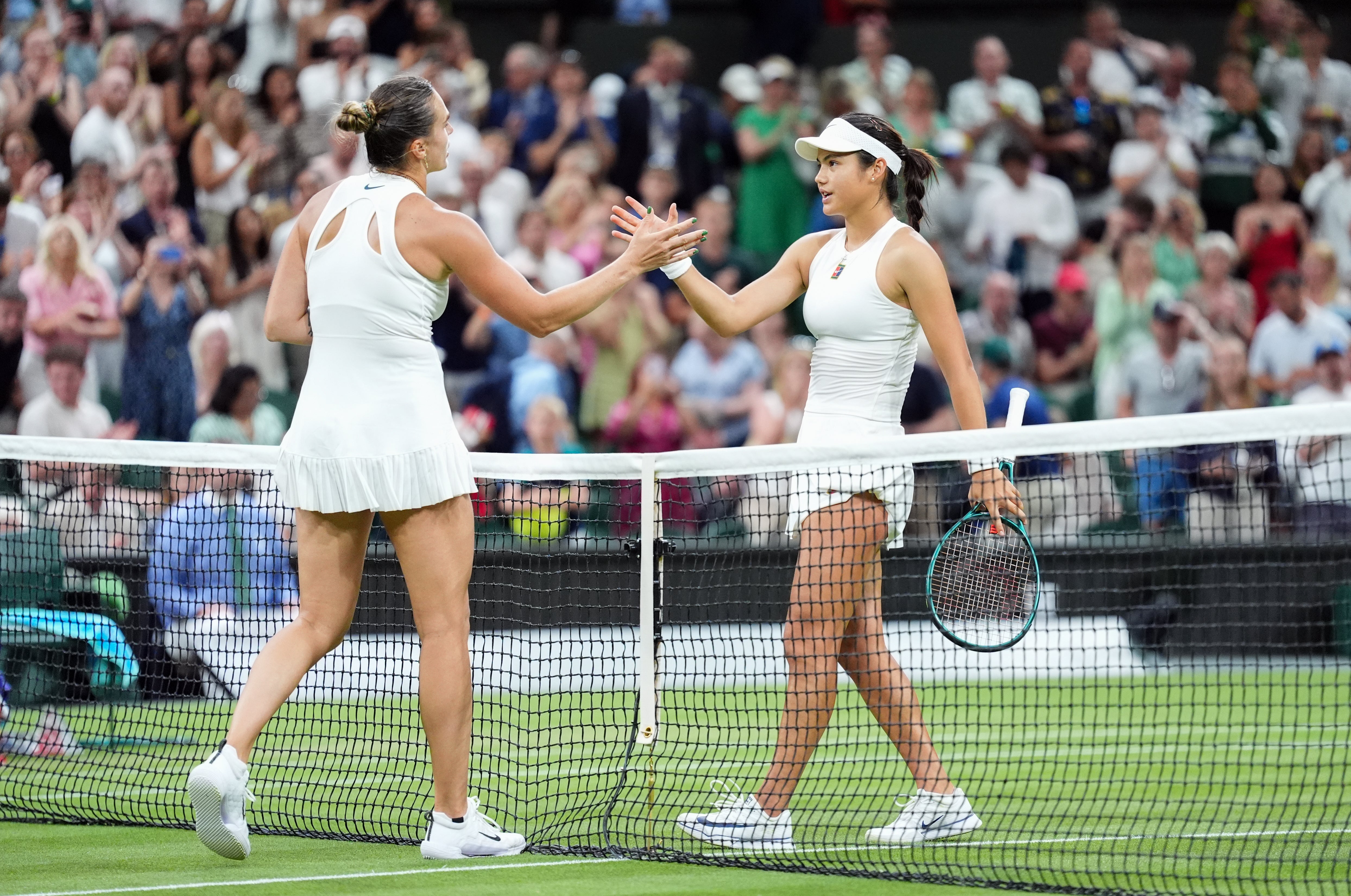 Emma Raducanu, right, shakes hands after losing to Aryna Sabalenka (Adam Davy/PA)