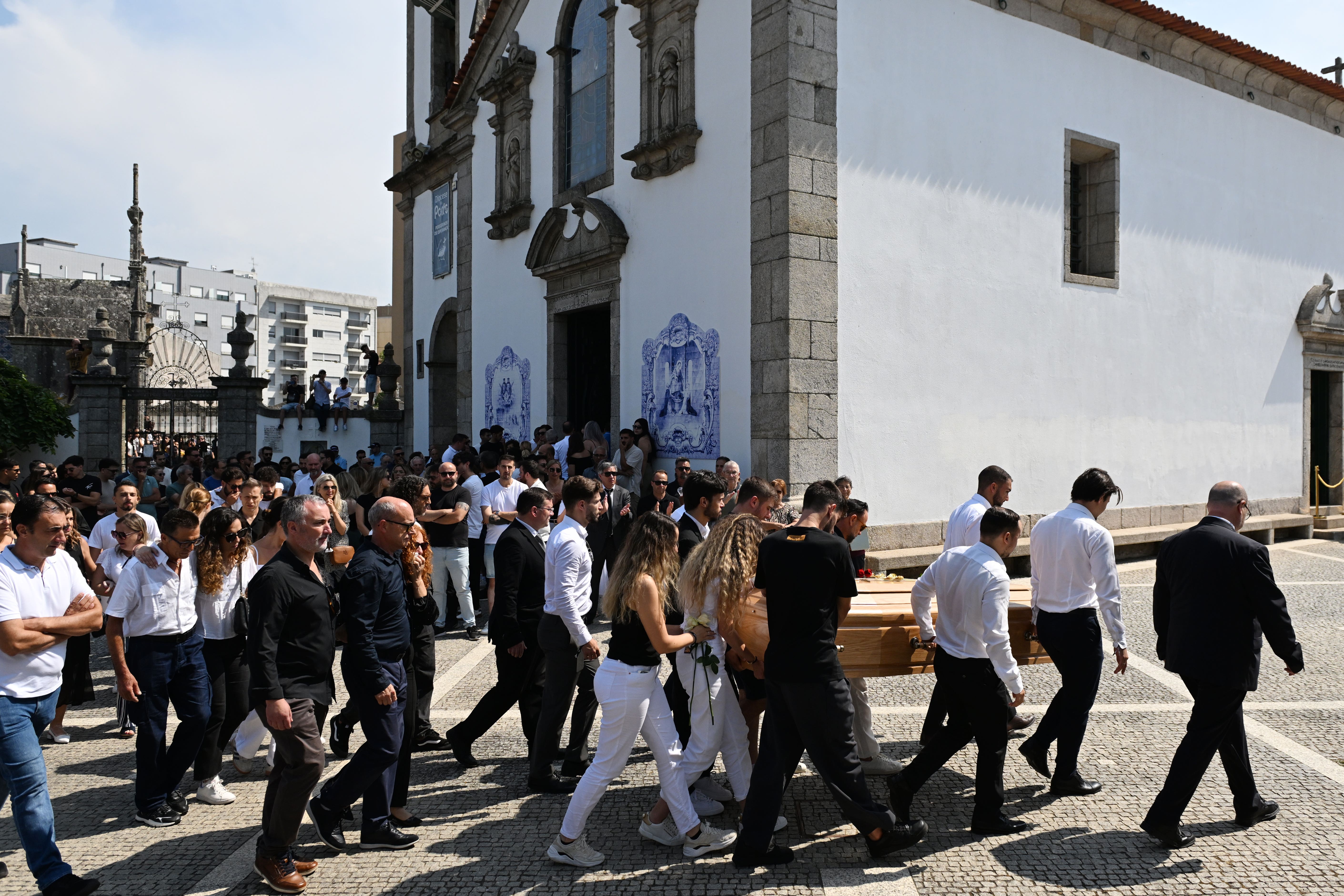 Diogo Jota’s wife Rute Cardoso walks with the coffin after the funeral of the footballer and his brother in Portugal (PA)