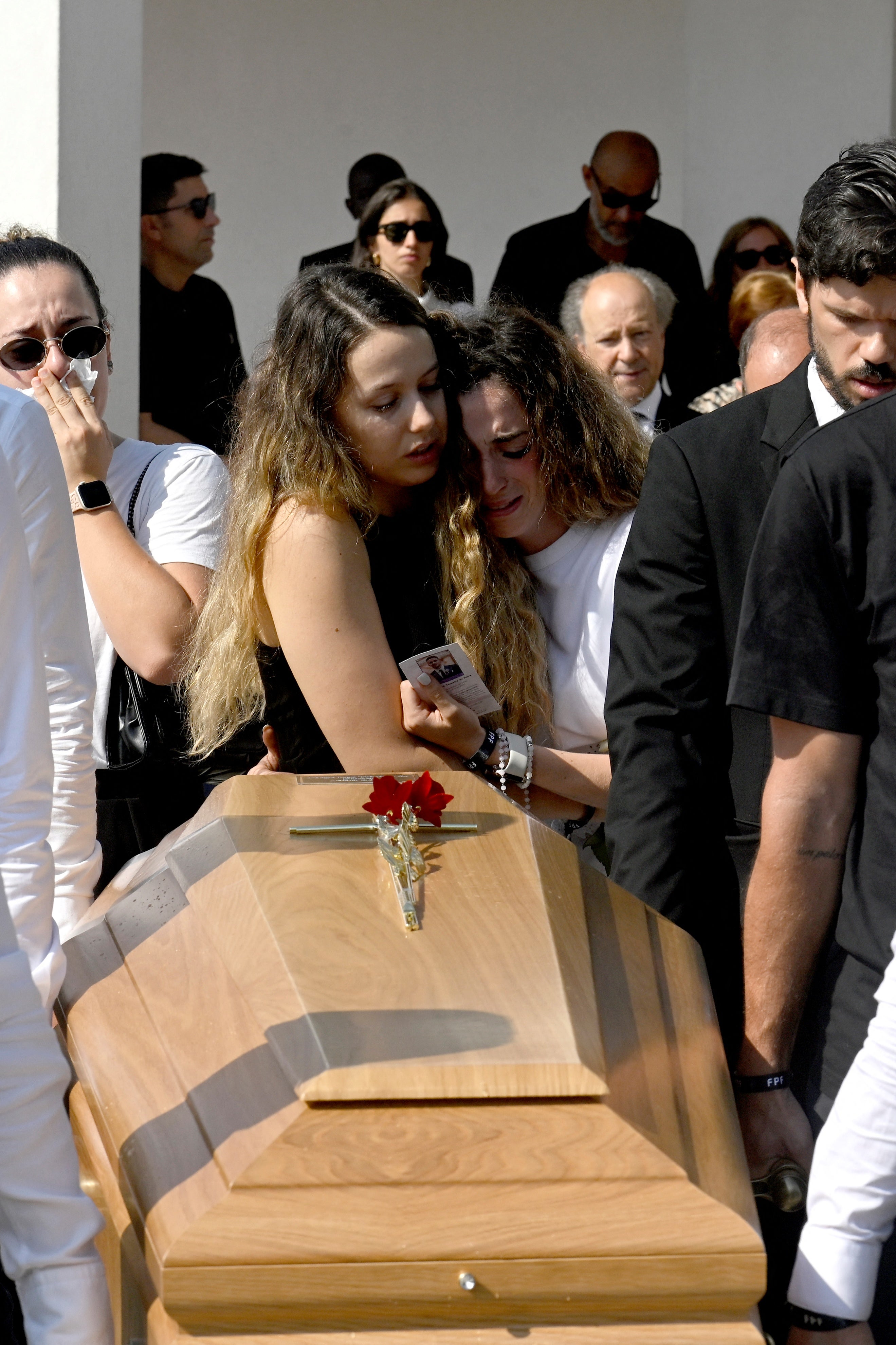 Diogo Jota's wife Rute Cardoso and her sister react as pallbearers carry the coffin