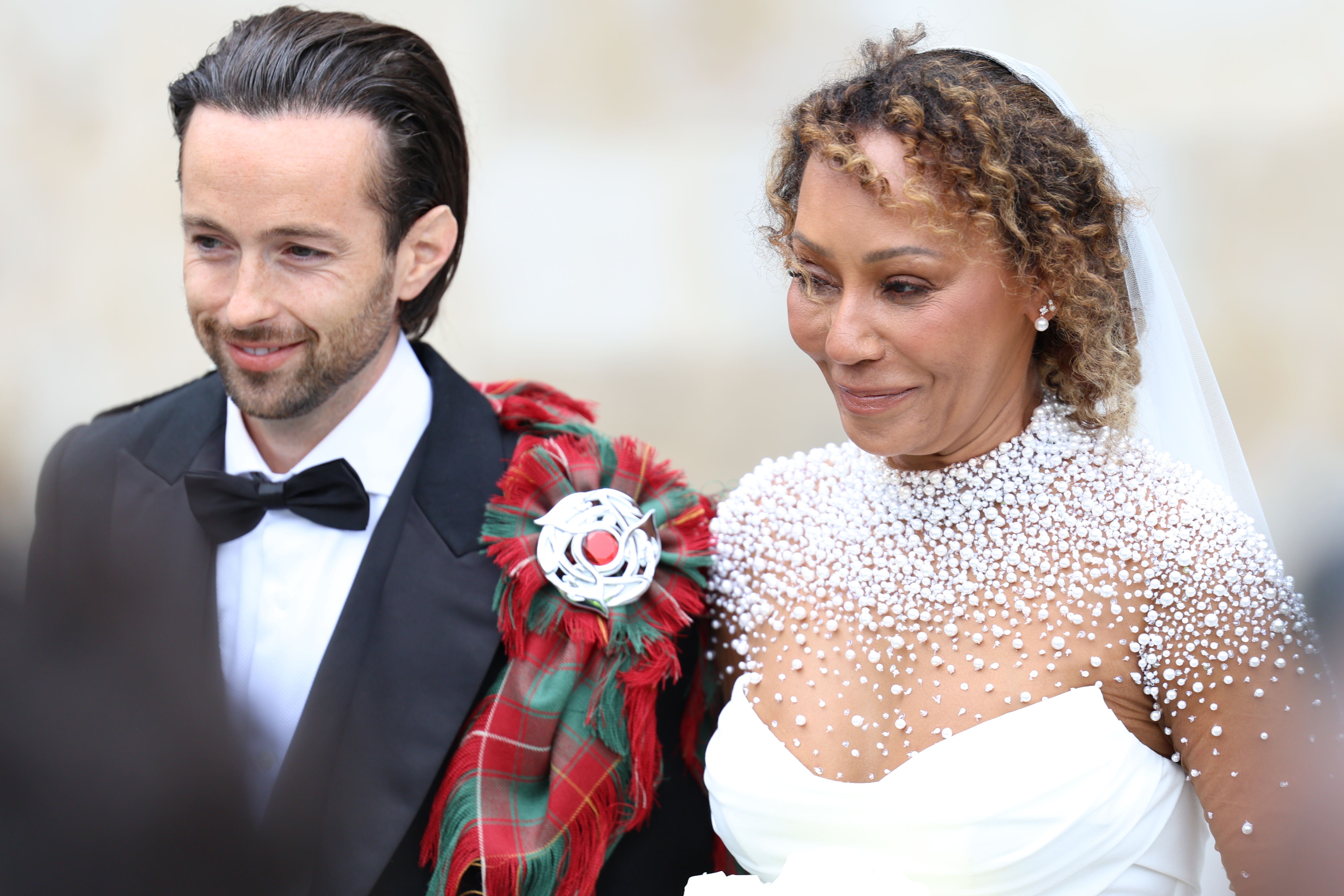 Spice Girl Melanie Brown, Mel B, and her husband hairdresser Rory McPhee leave St Paul’s Cathedral, London, following their wedding (Toby Shepheard/PA)