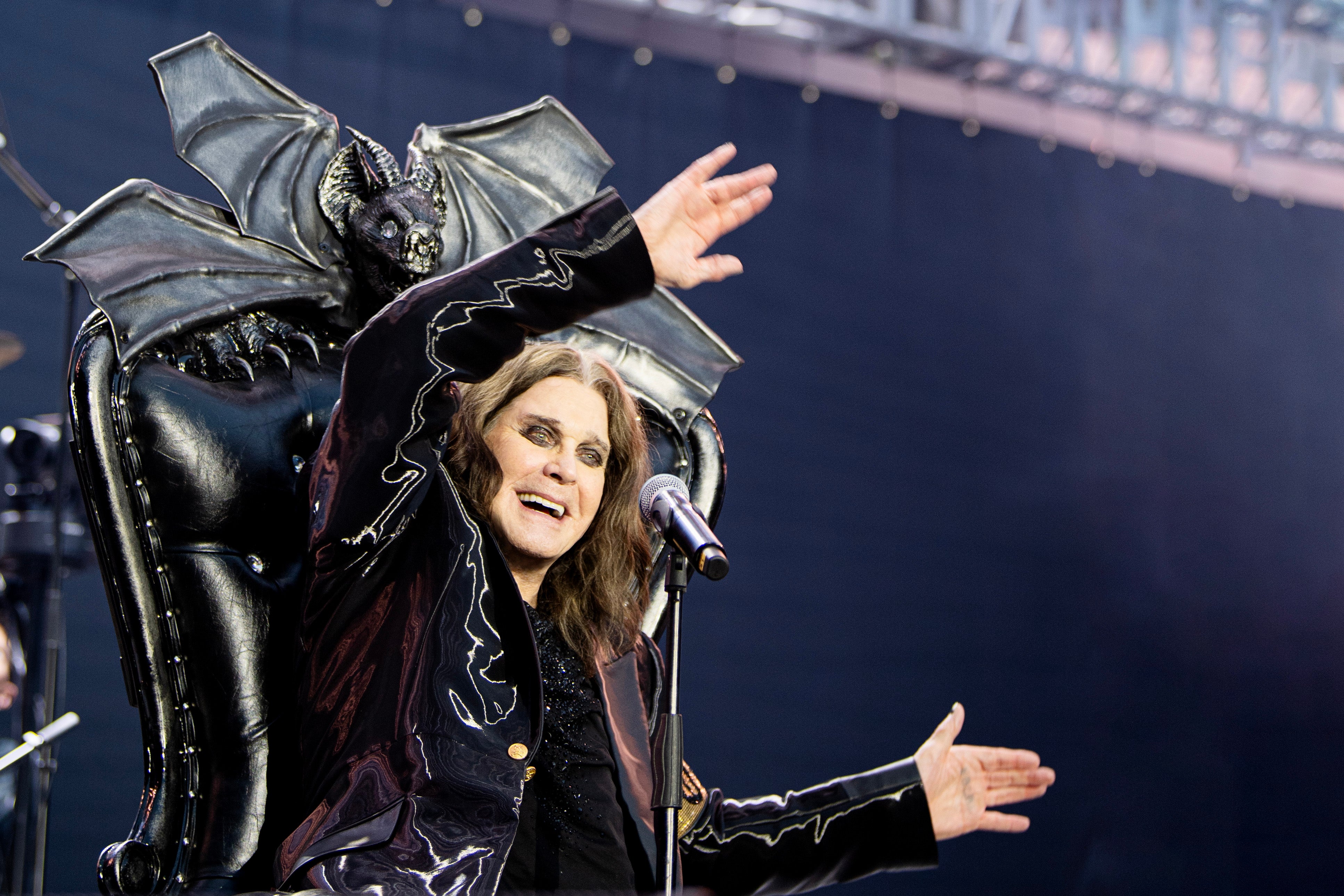 Ozzy Osbourne waves with their arms playing his final show