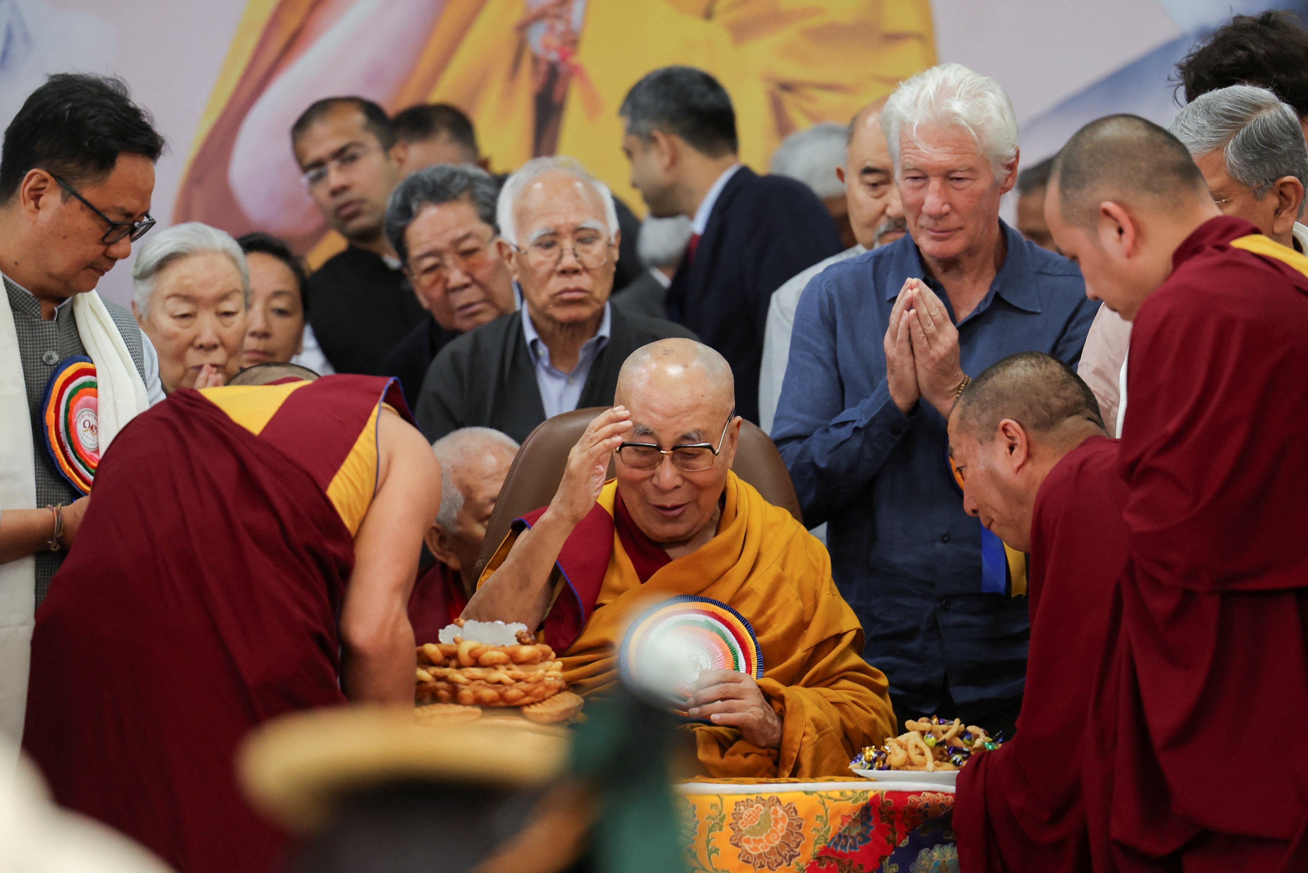 Tibetan spiritual leader, the 14th Dalai Lama, is served food on his 90th birthday celebration at the Tsuglagkhang, also known as the Dalai Lama Temple complex