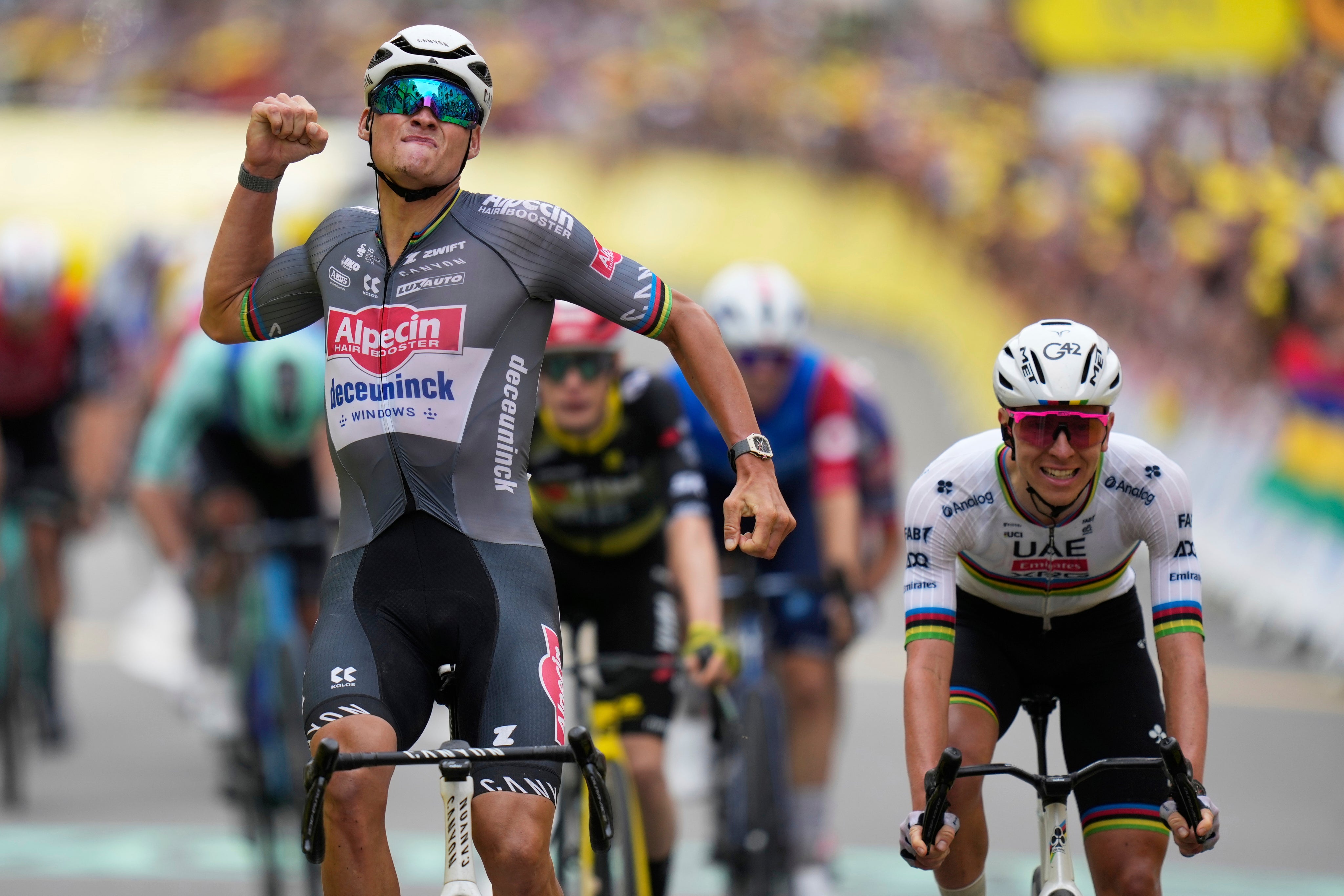 Mathieu van der Poel celebrates crossing the line to win stage two of the Tour de France
