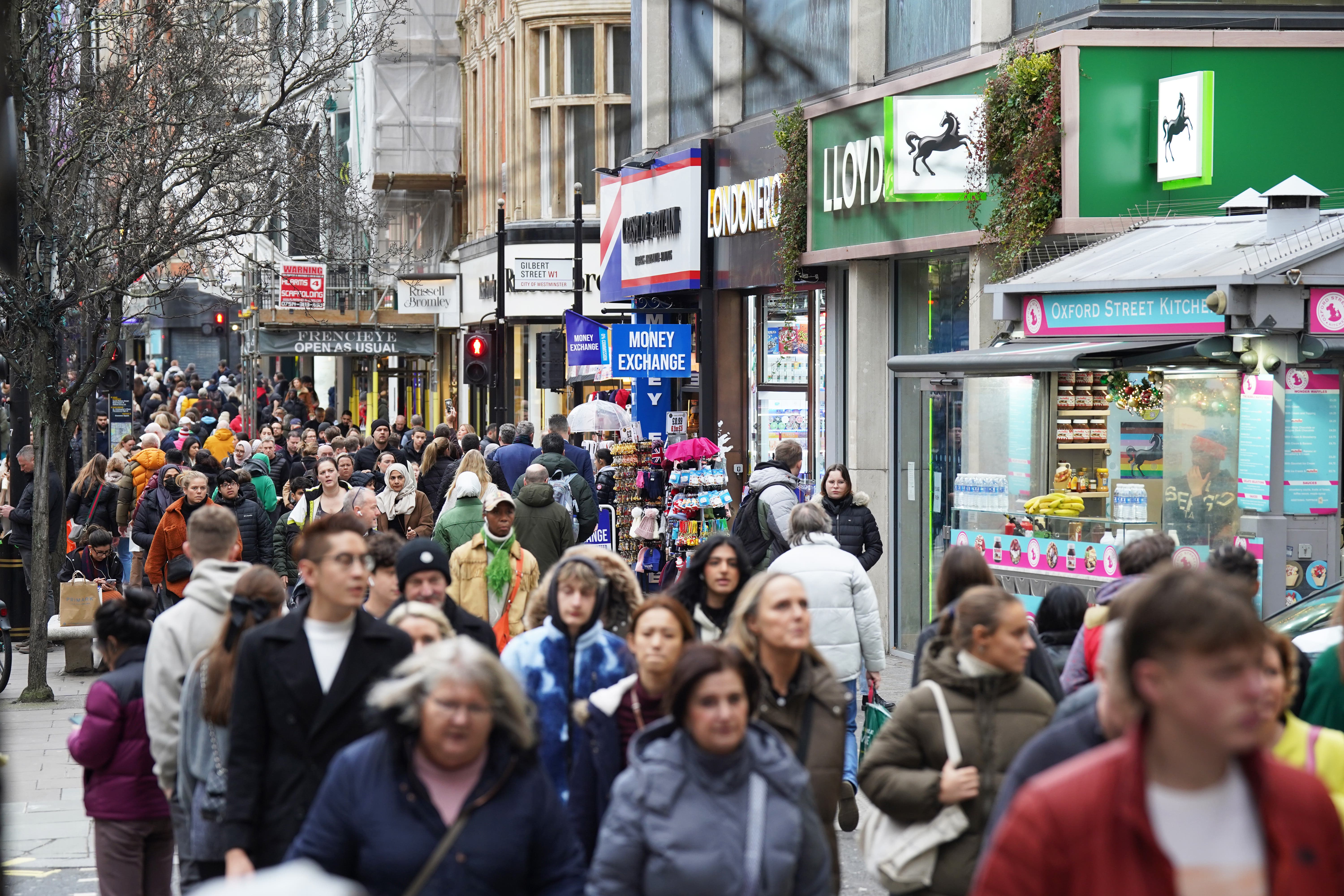 Shoppers on Oxford Street in London. High street footfall improved last week amid a boost from Oasis concerts and Wimbledon (Lucy North/PA)